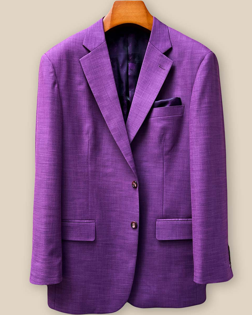 Close-up detail of mulberry horn buttons on dark orchid purple sport coat showing natural texture and premium button selection