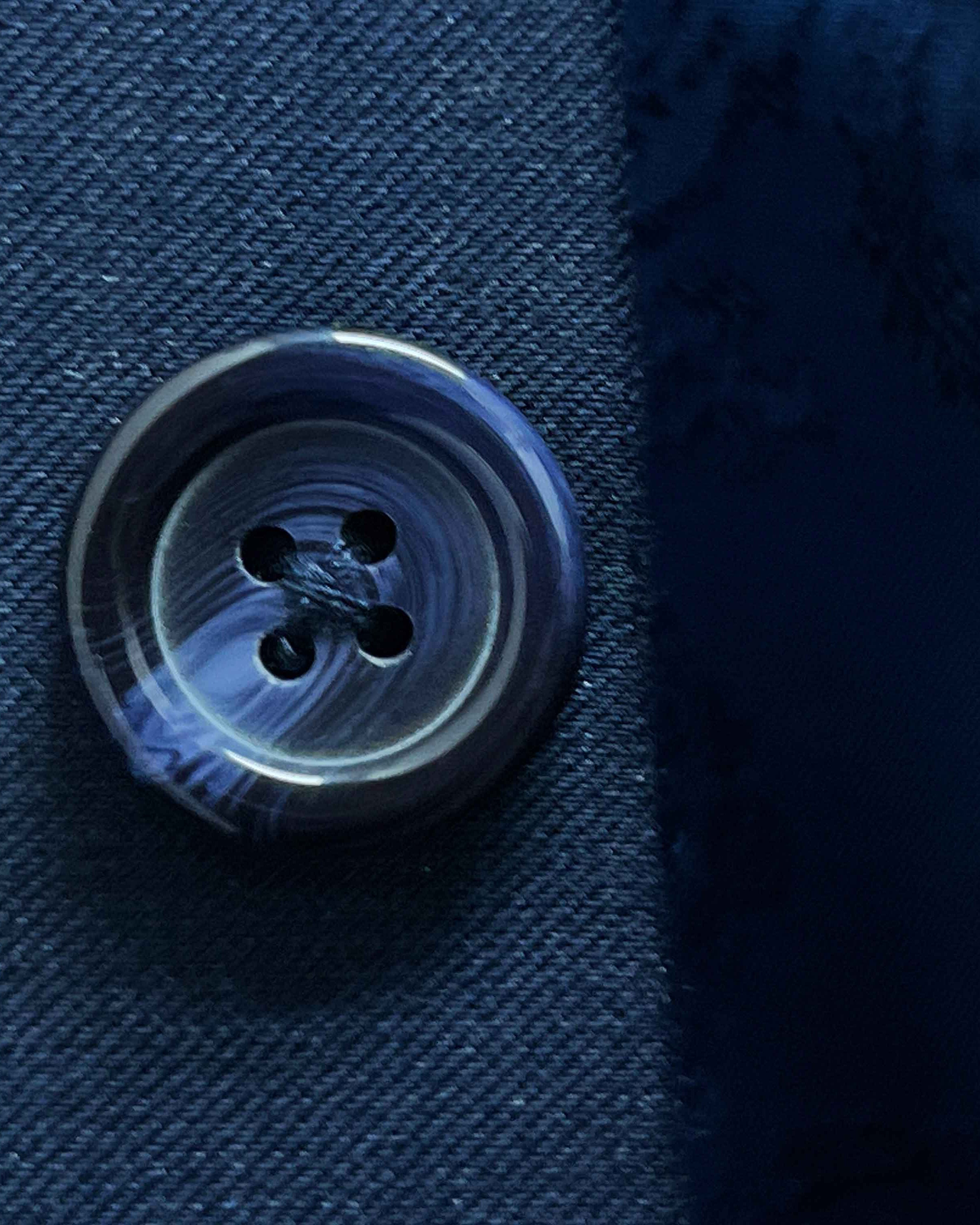 Close-up of a button on blue fabric