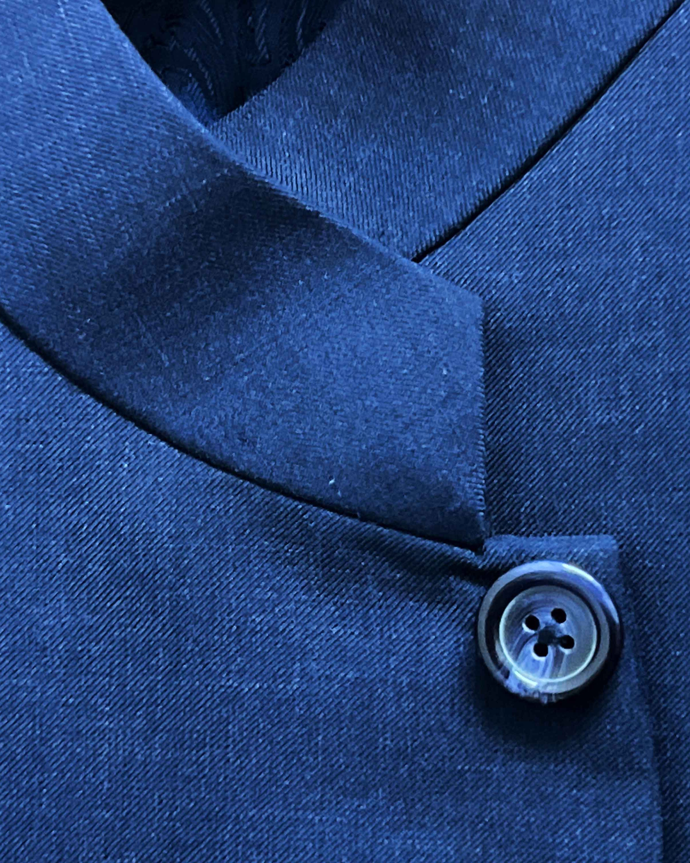 Close-up of a blue button on a garment