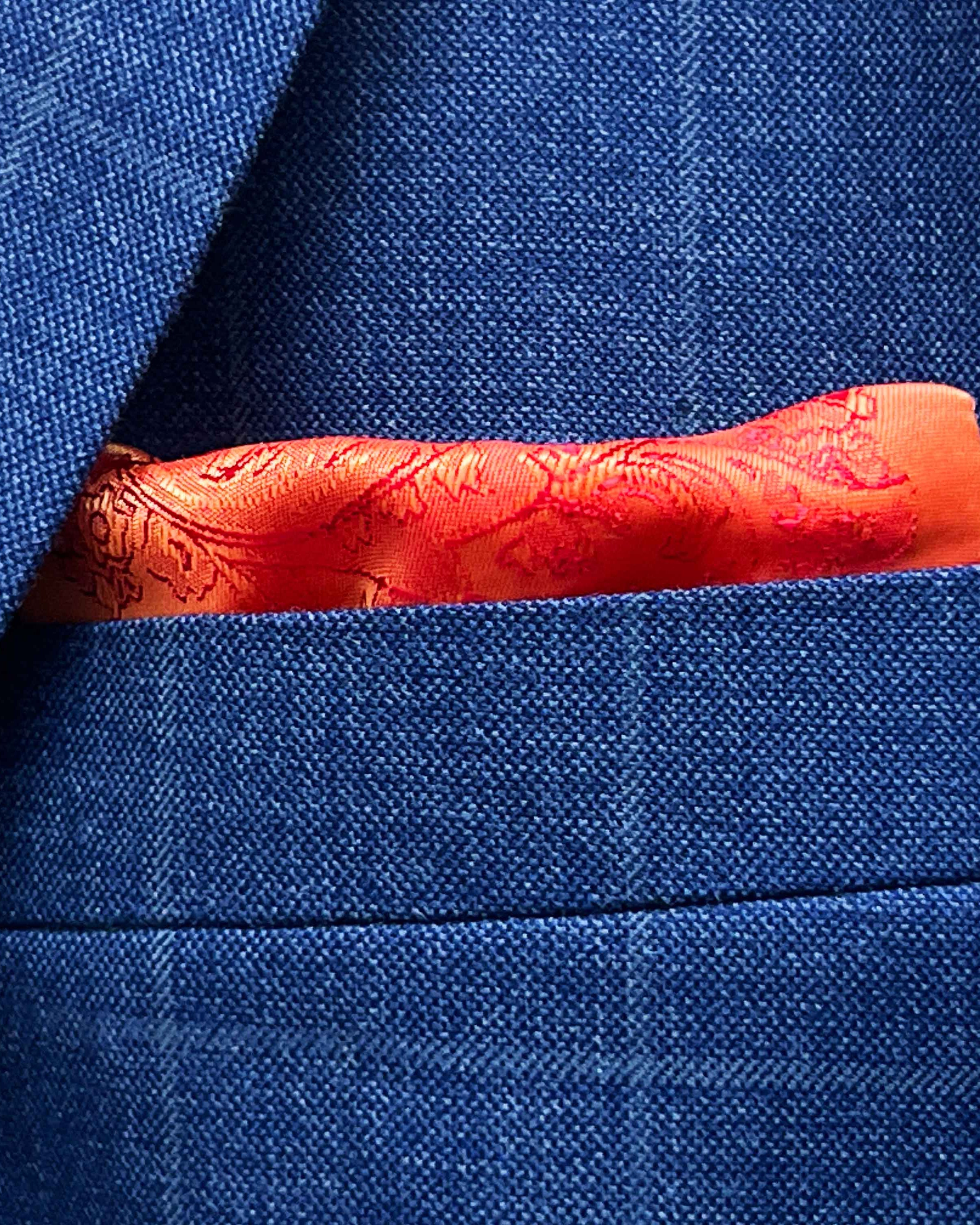 Breast pocket of deep blue windowpane check suit jacket with built-in pocket square holder and hand-finished edges