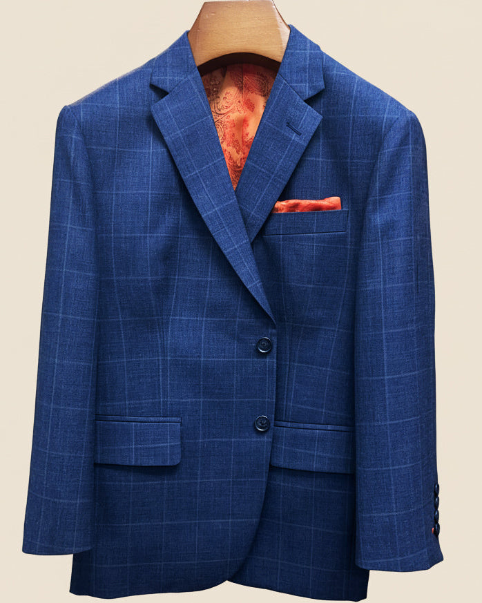 Front button panel of deep blue windowpane check suit jacket featuring marbled dark blue horn buttons and hand pick stitching