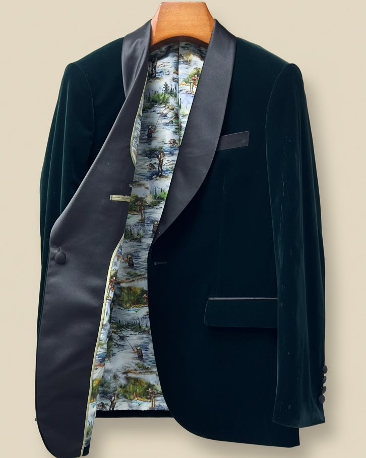 Dark green velvet blazer with floral lining on a beige background