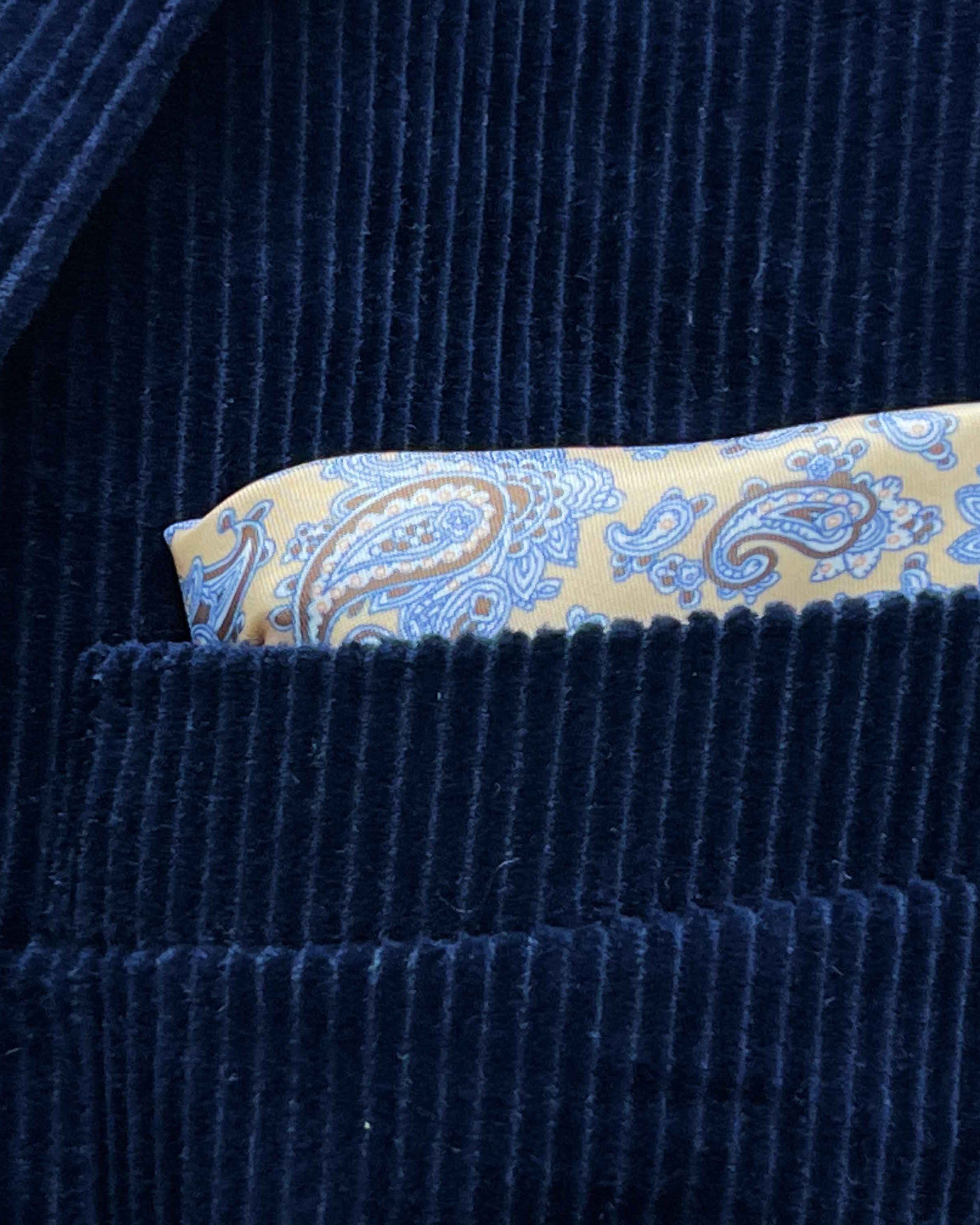 Breast pocket of deep navy blue corduroy sport coat with built-in pocket square holder and hand-finished edges
