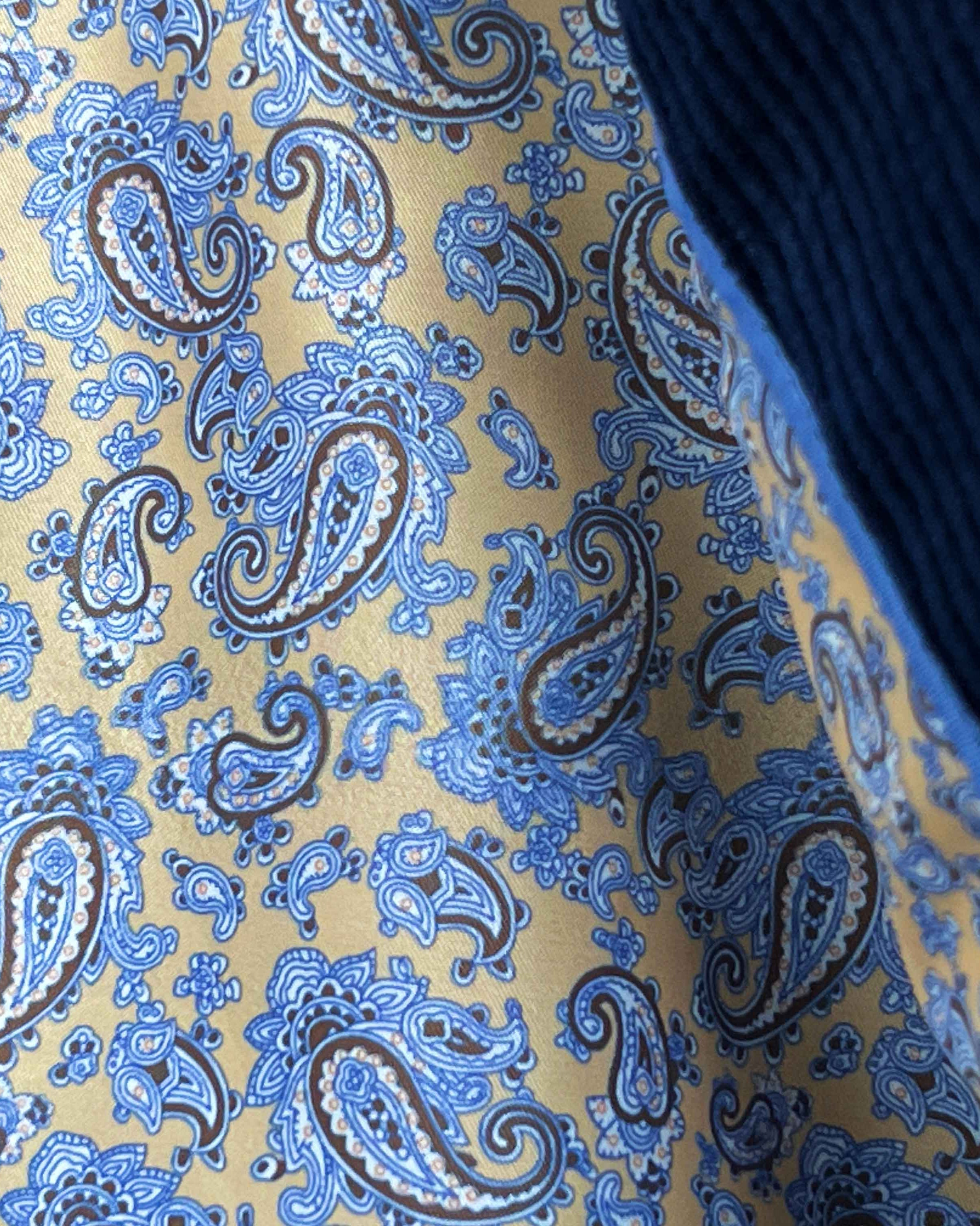 Colorful flash lining detail visible at jacket cuffs and vents in tan with light blue and brown paisley pattern