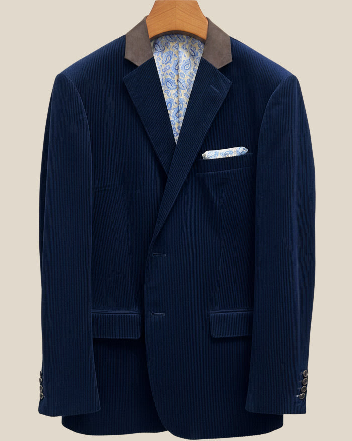 Close-up view of deep navy blue corduroy sport coat showing contrast light blue accent buttonhole with hand-finished stitching detail