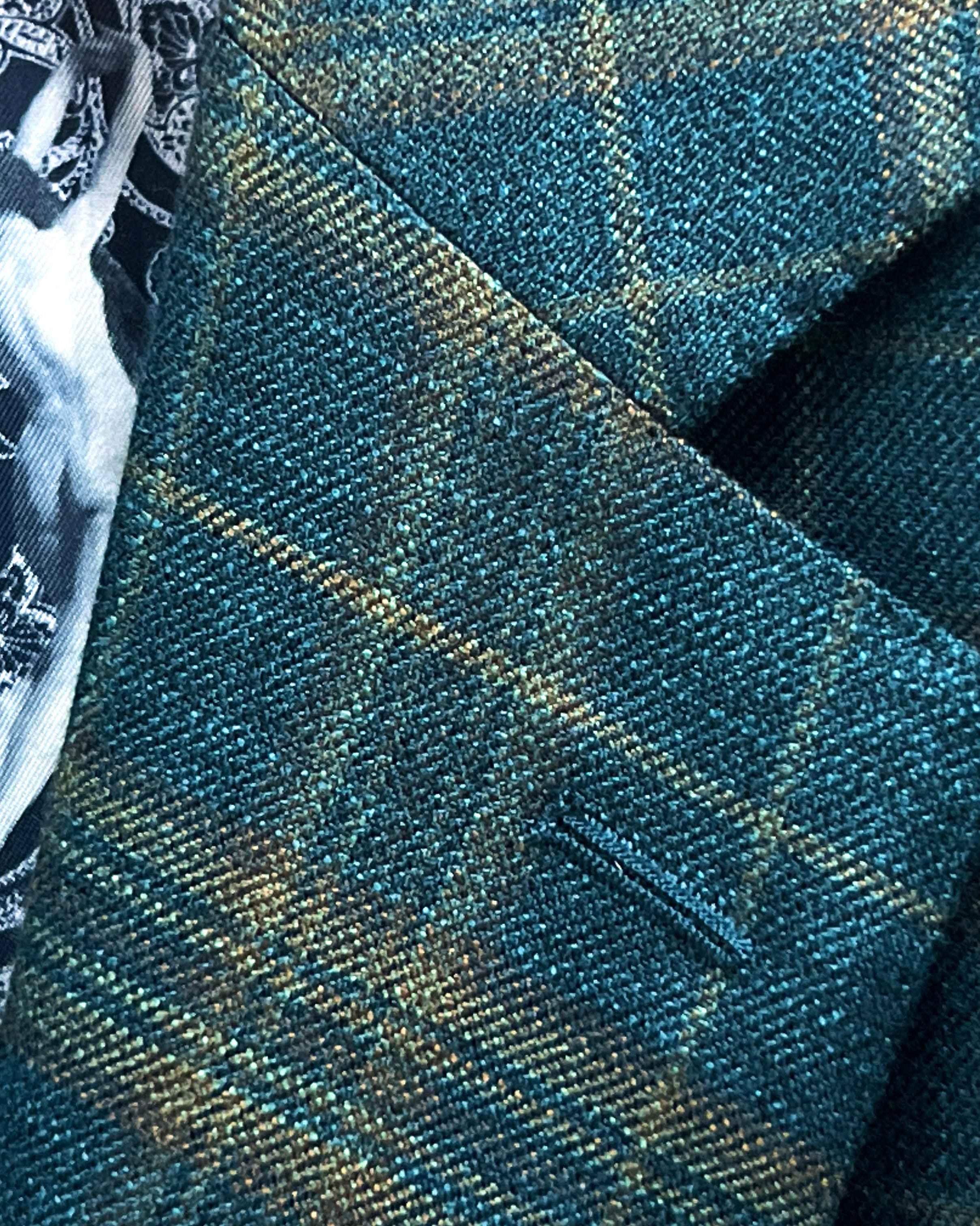 Classic notch lapel detail on deep teal green multi check suit jacket showing hand pick stitching and plaid check pattern