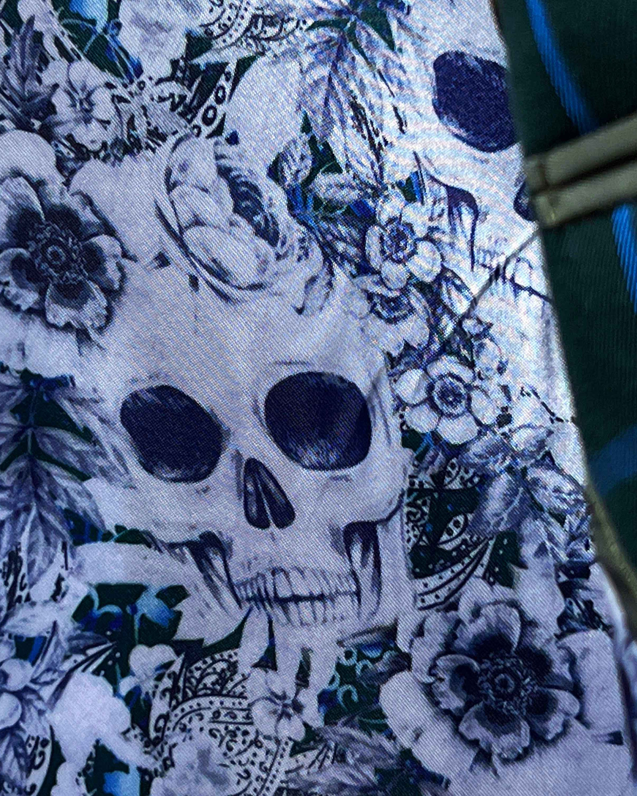 Colorful flash lining detail visible at jacket cuffs and vents in white and light blue floral and skull pattern