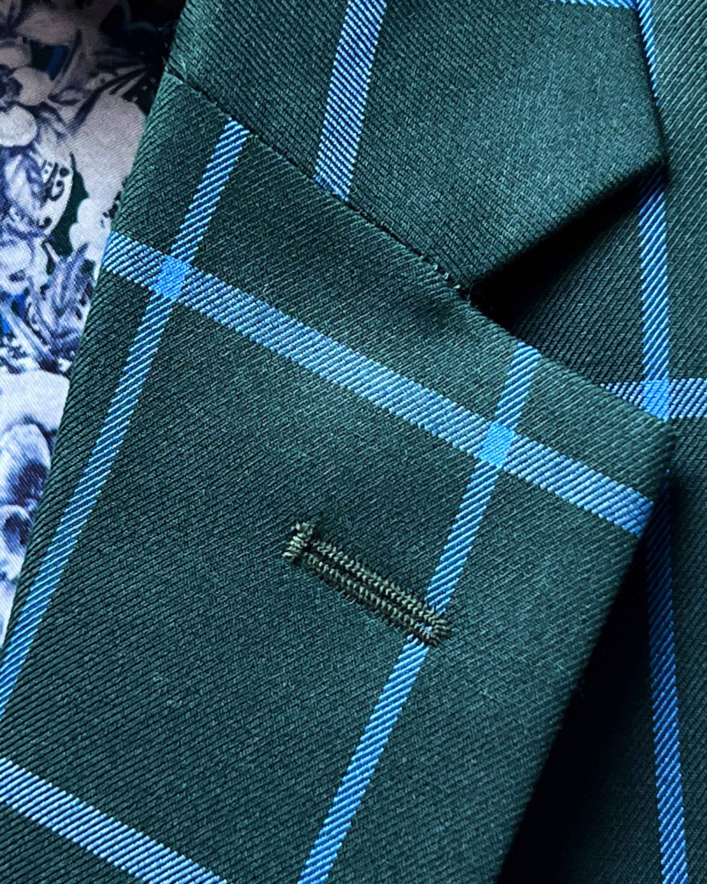 Classic notch lapel detail on forest green windowpane sport coat showing hand pick stitching and bright blue check pattern