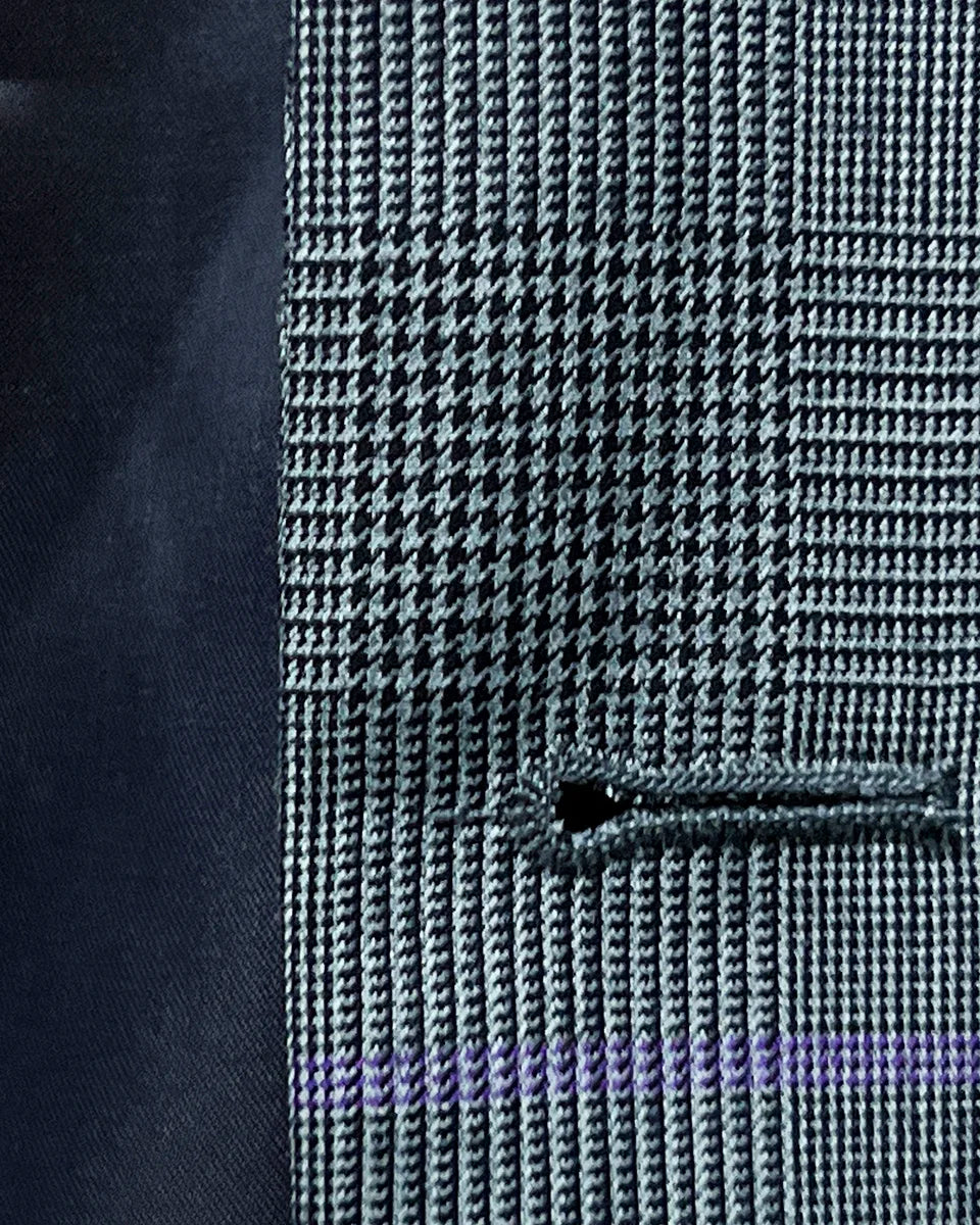 Macro view of precisely stitched buttonhole on grey suit fabric