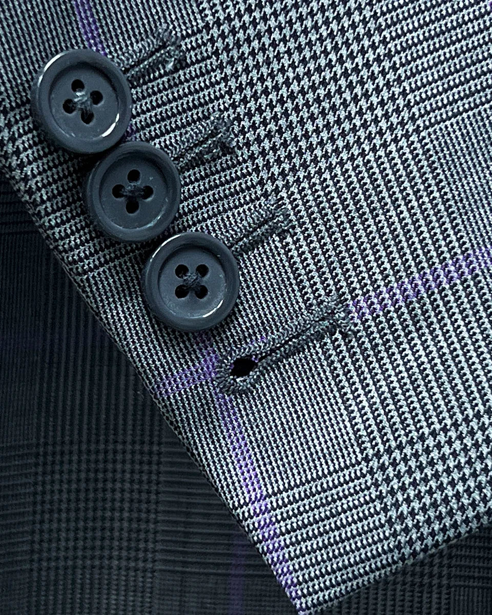 Detailed shot of suit jacket sleeve, showcasing working buttonholes and horn buttons