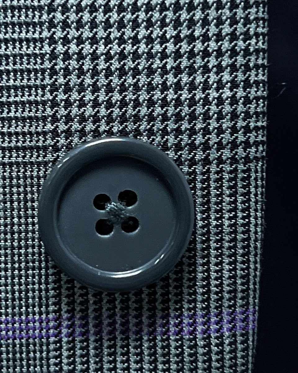 Detailed shot of grey horn buttons, showcasing their unique marble-like texture