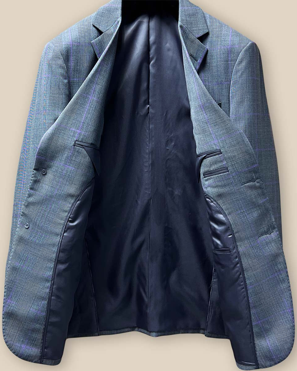 Full view of suit jacket interior, showcasing smooth grey bemberg lining and tailoring details