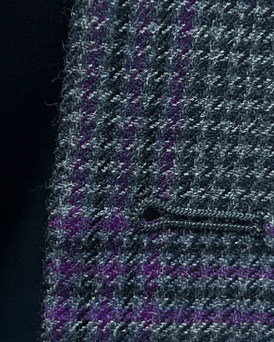 Macro view of precise buttonhole stitching on custom grey houndstooth sport coat