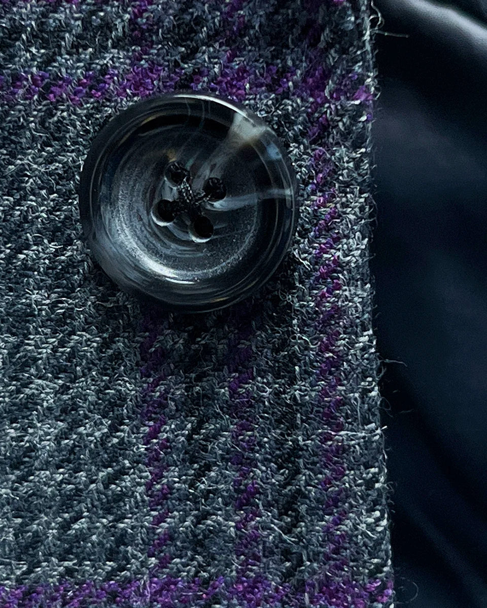 Detailed view of grey marble horn buttons used on custom plaid sport coat