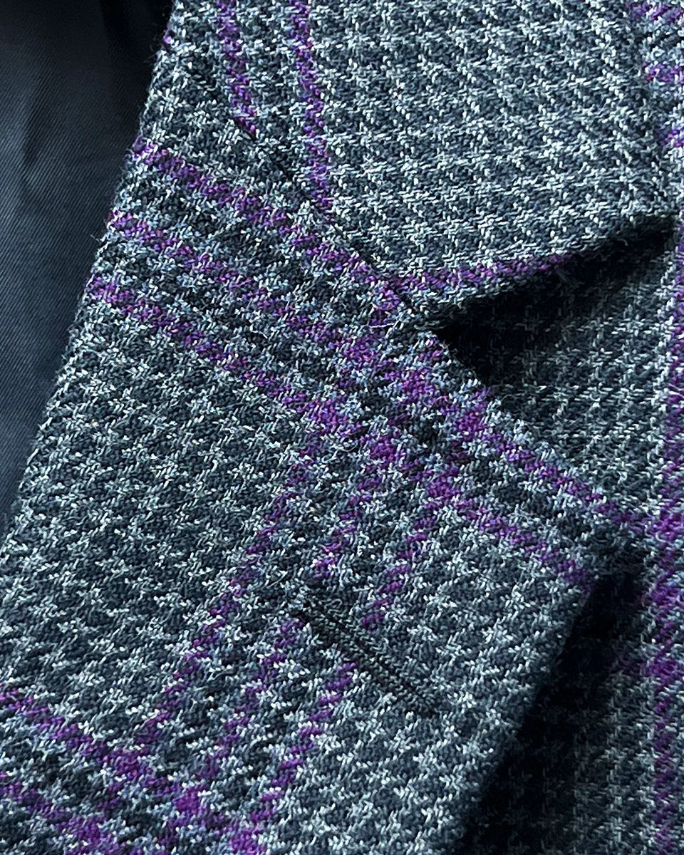 Detail of classic notch lapel on custom grey houndstooth sport coat with purple plaid accents