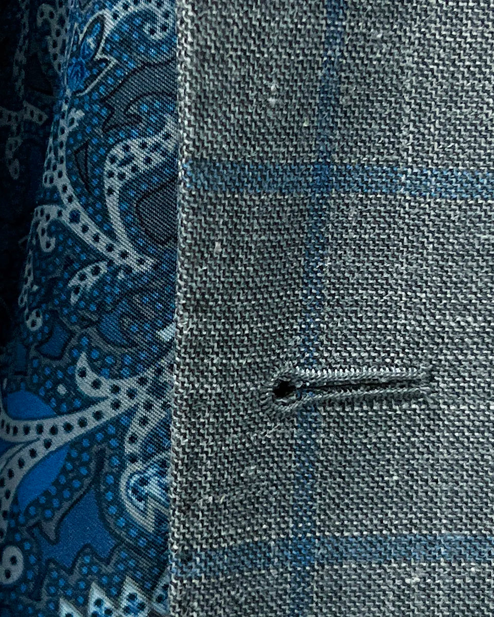Detailed view of the buttonhole stitching on the Westwood Hart grey with medium blue windowpane men's sport coat.
