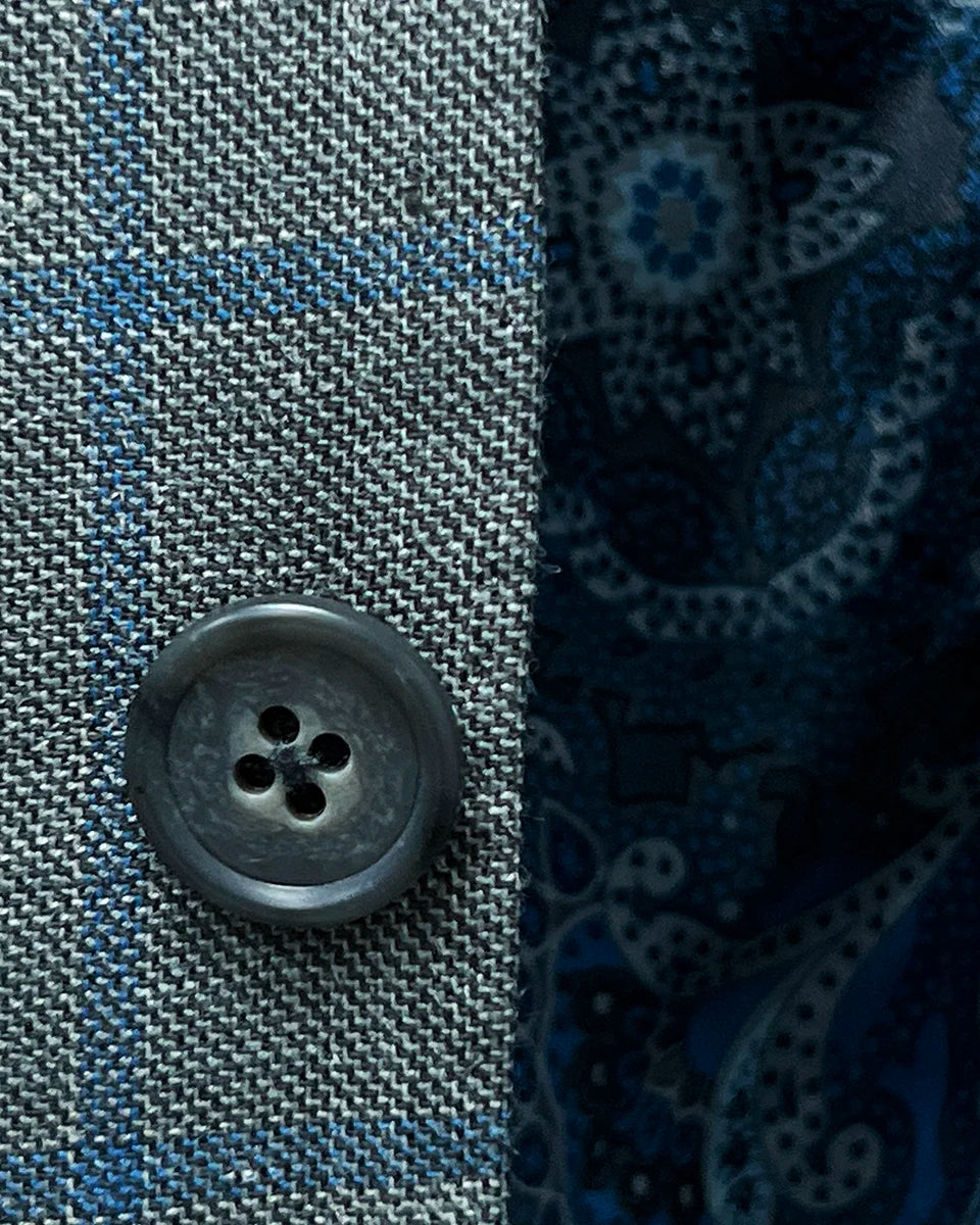Close-up of the grey horn buttons on the Westwood Hart grey with medium blue windowpane men's sport coat.