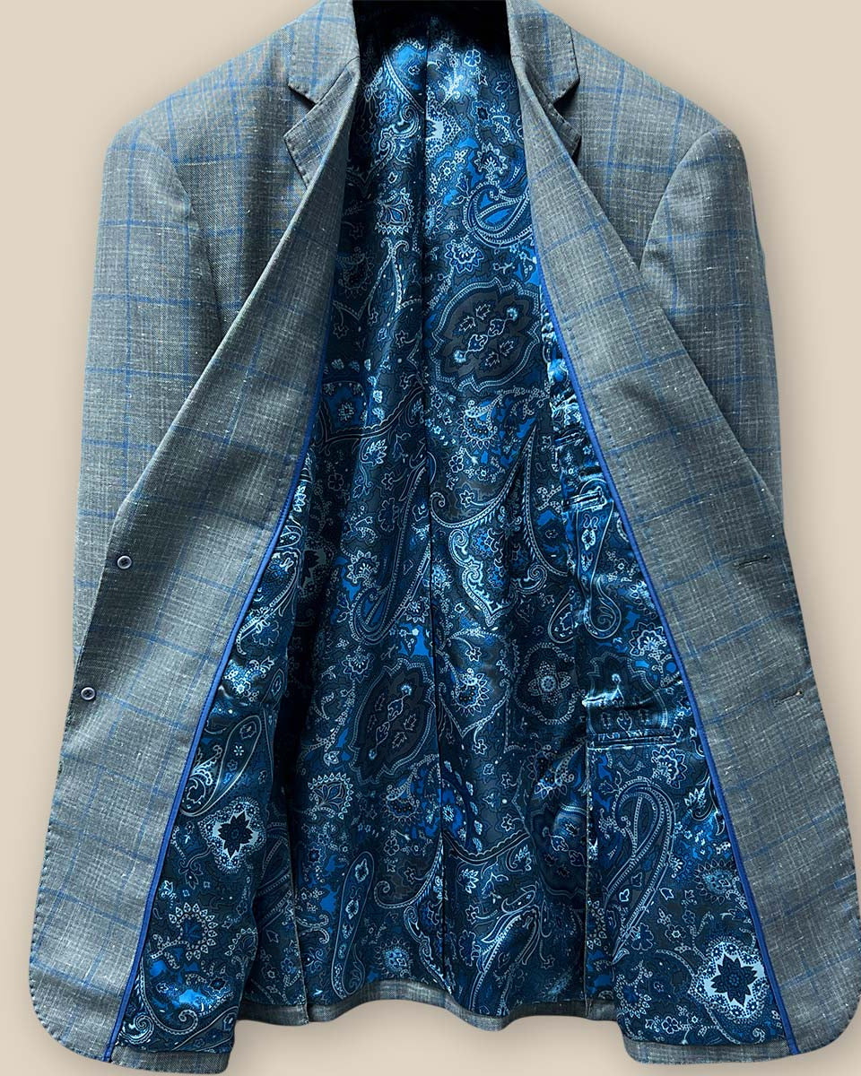 Detailed view of the fancy flash navy with blue design lining inside the Westwood Hart grey with medium blue windowpane men's sport coat.
