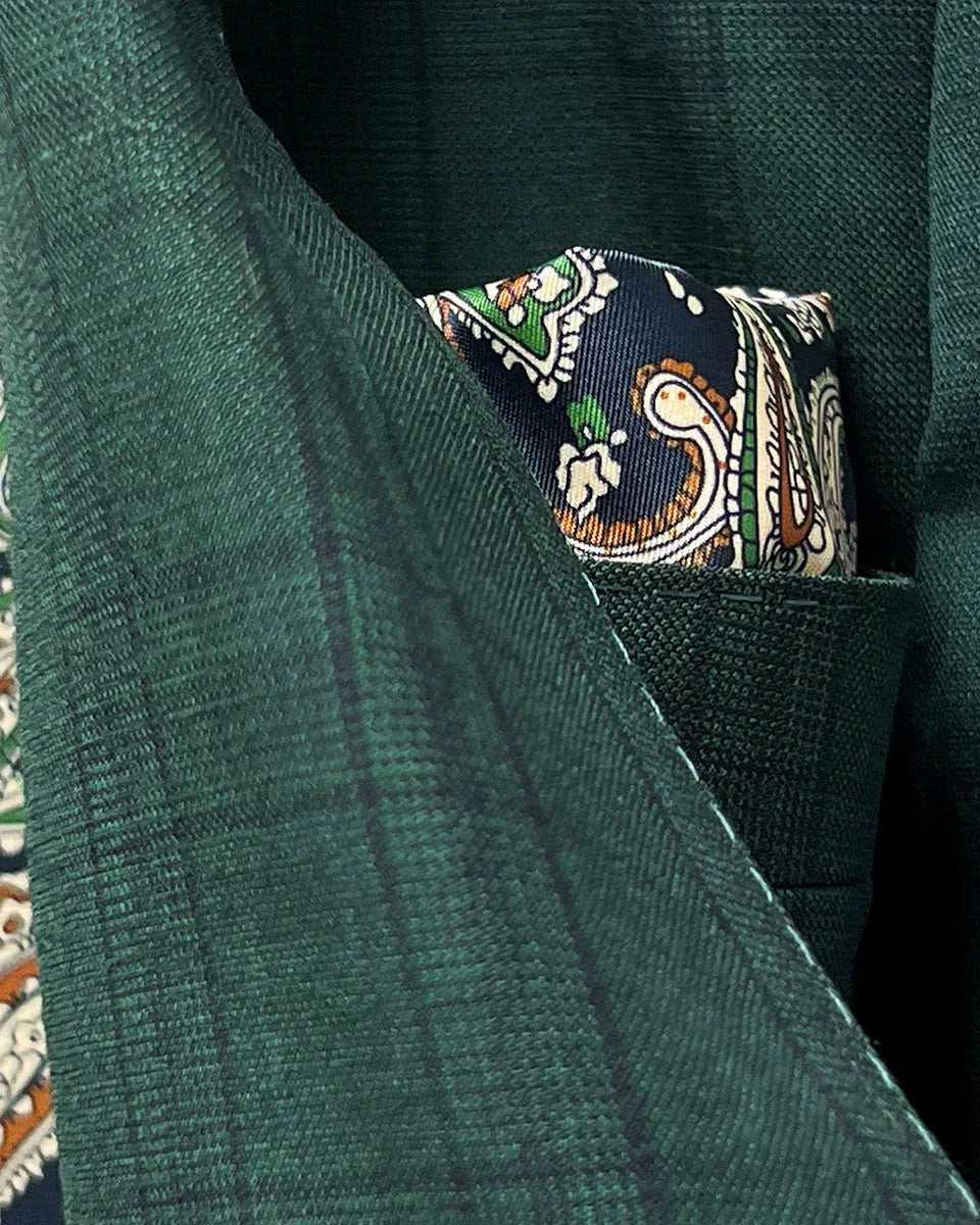 Detailed close-up of Super 120's wool fabric texture showing hunter green base with sophisticated black checkered pattern