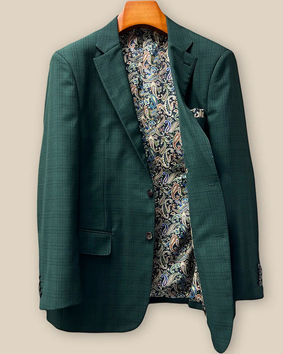 Interior left side of hunter green checkered sport coat jacket displaying vibrant paisley lining with navy, rust, green and light blue with inner pocket