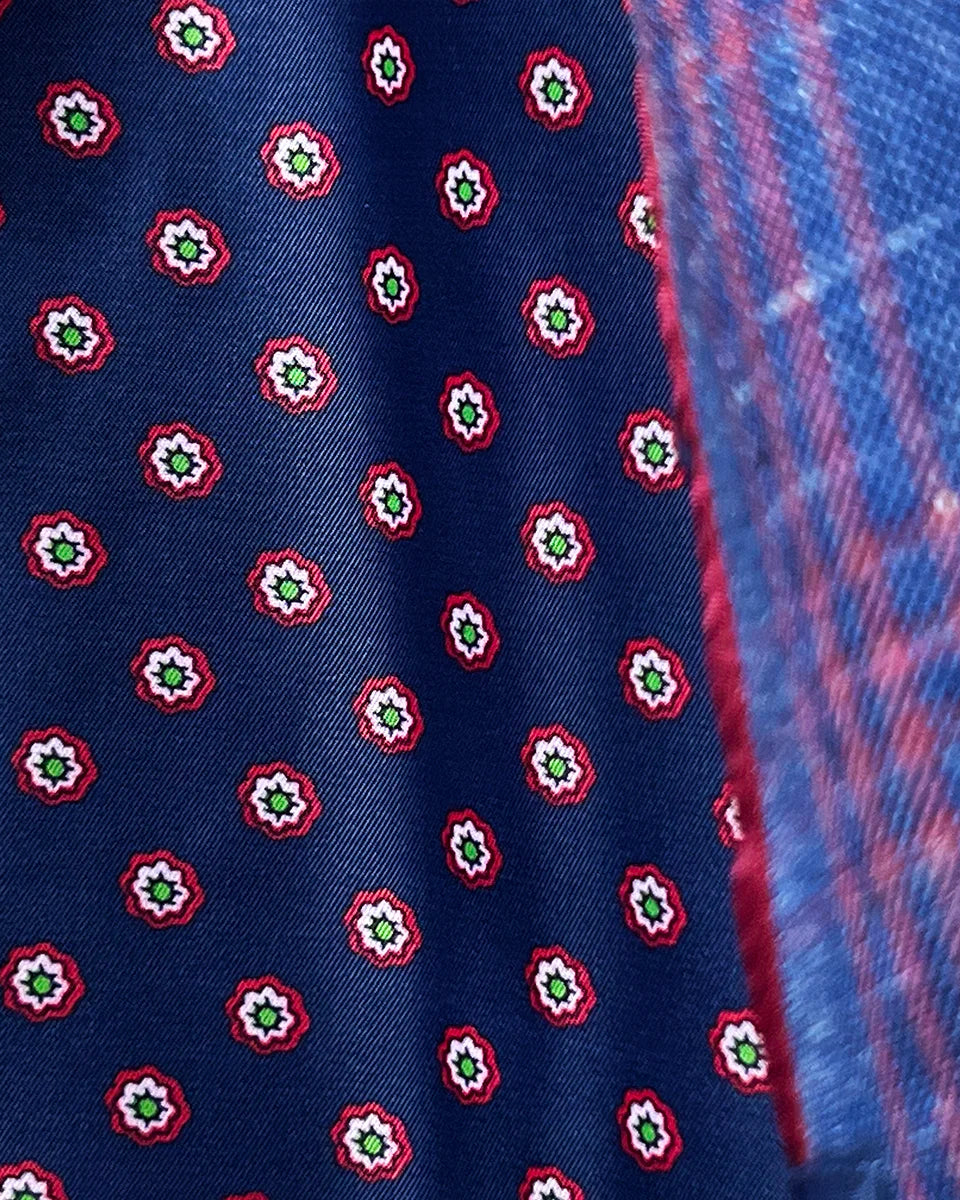 Detailed view of hand-executed pick stitching along lapel edges, showcasing the meticulous craftsmanship in dark berry maroon thread