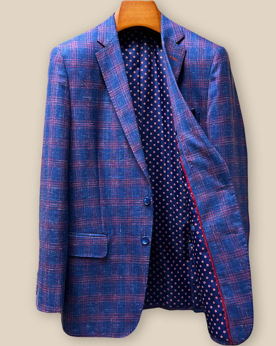 Interior left side view of custom sport coat revealing navy geometric pattern flash lining with red and cream accents against premium linen-wool blend fabric
