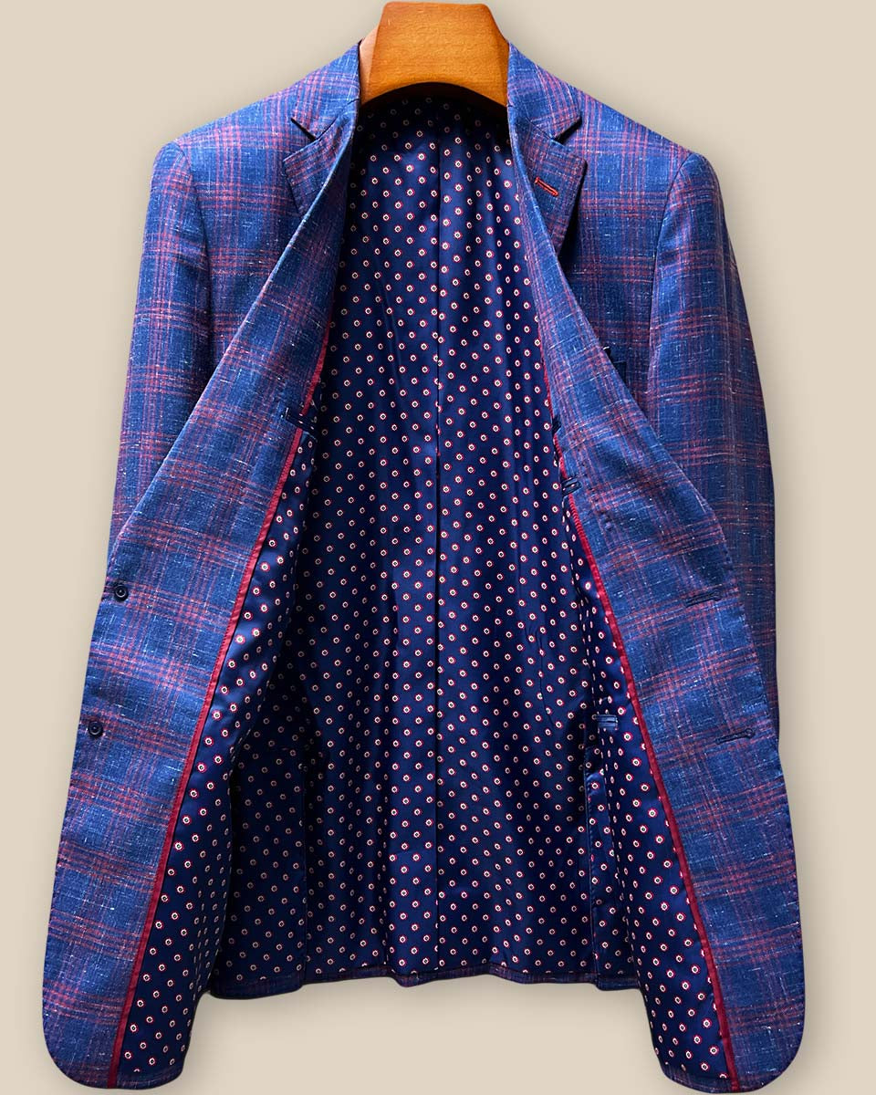 Full interior lining display showing navy base with red and cream geometric pattern flash lining, brand label, and internal construction details