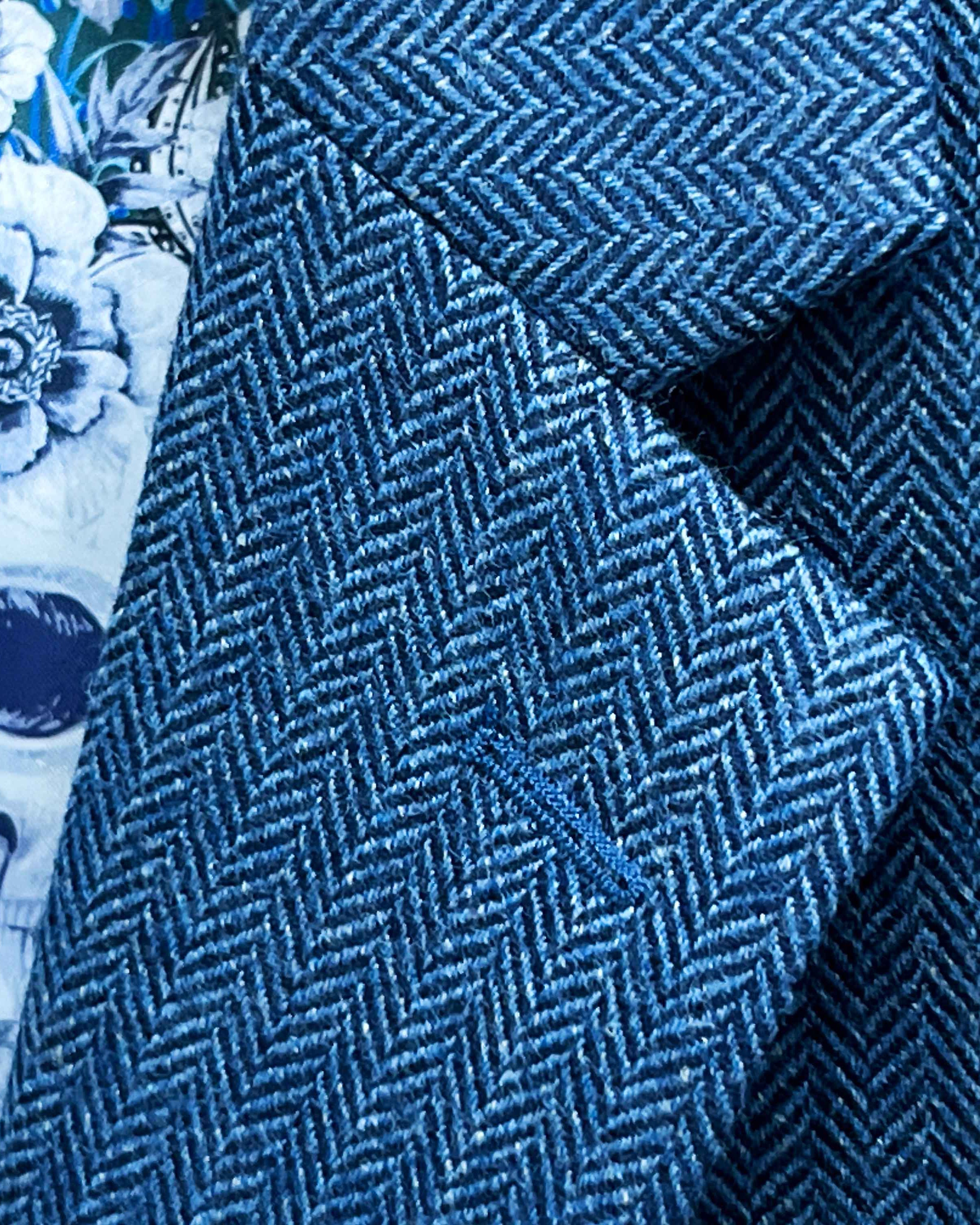 Classic notch lapel detail on indigo blue herringbone tweed sport coat showing hand pick stitching and herringbone pattern