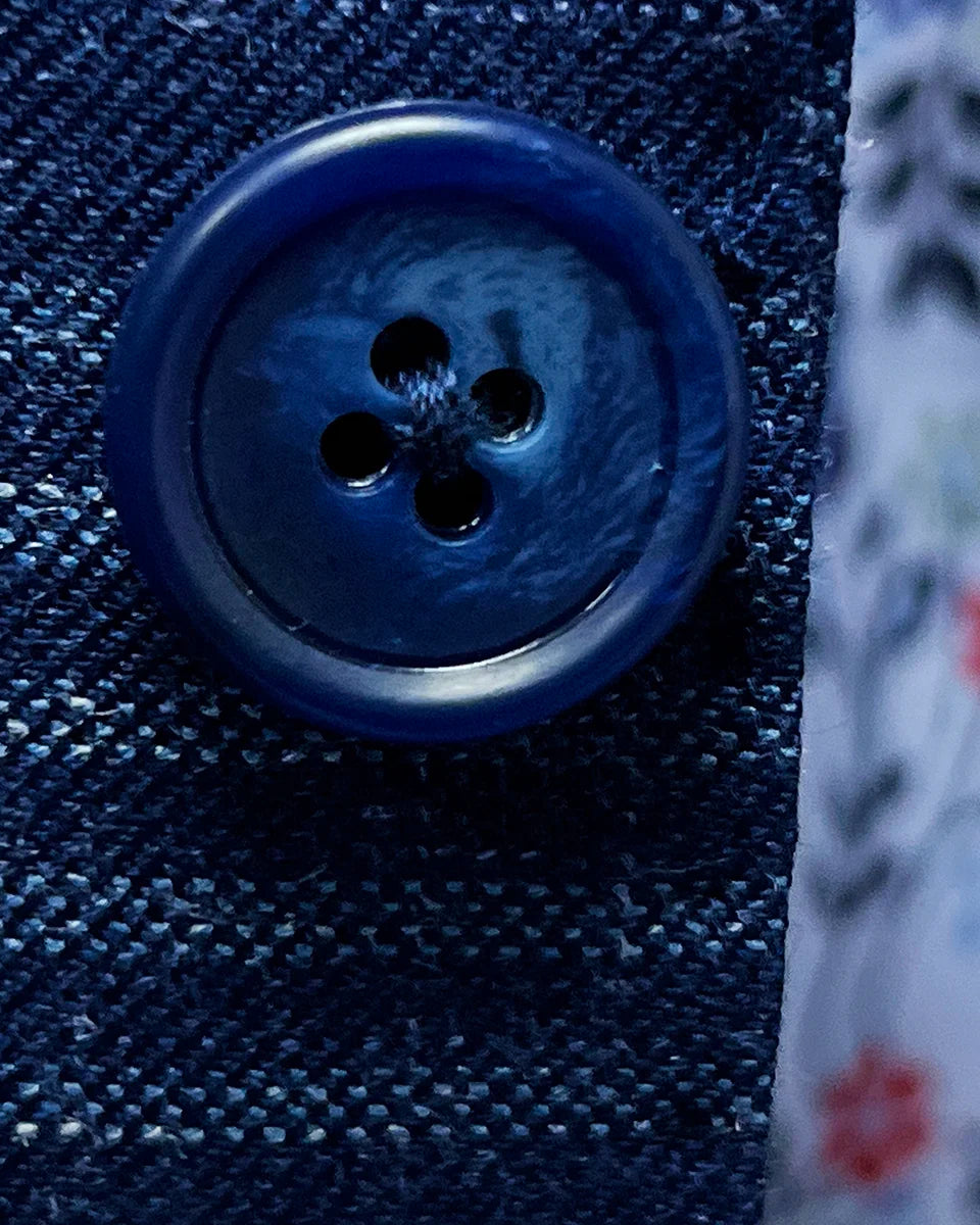 Close-up of navy horn marble buttons showing natural texture variations and premium quality hardware selection