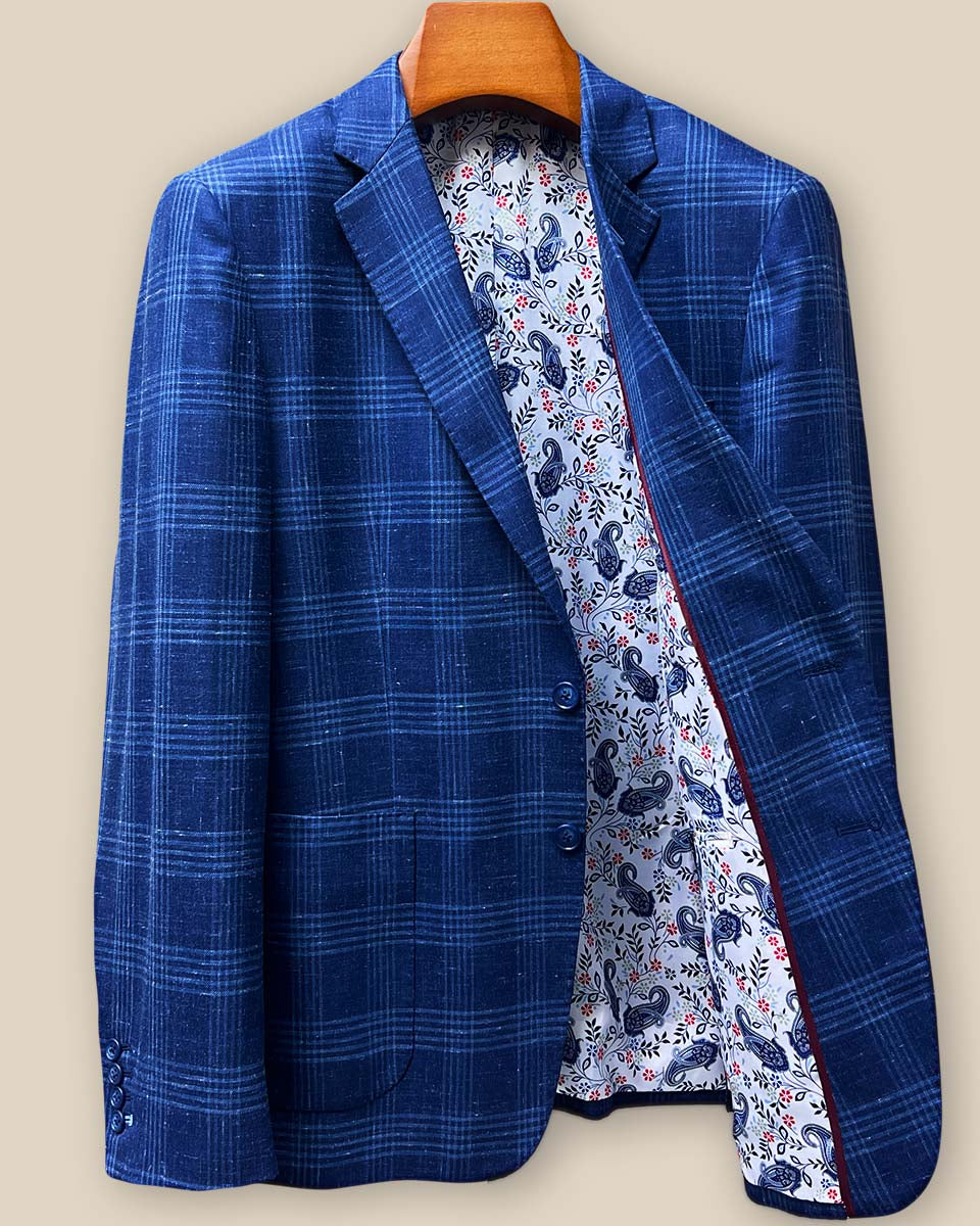 Interior left panel of custom sport coat revealing bright paisley lining with ornate medallion patterns in multi-tonal blue colorway