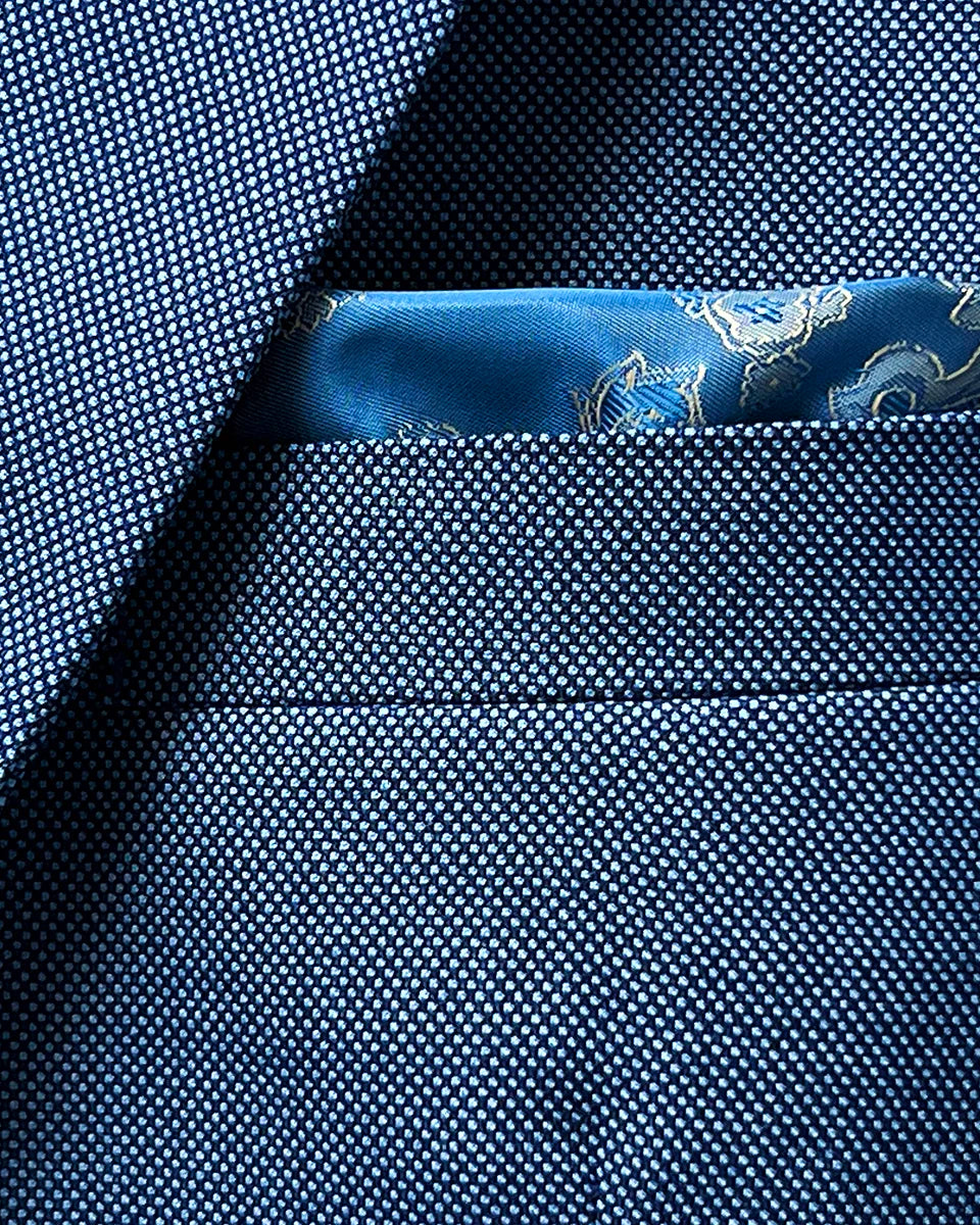 Close-up of suit jacket breast pocket with built-in pocket square in complementary color