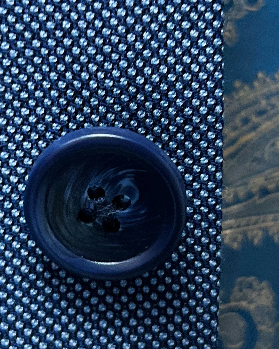 Detailed view of navy horn marble buttons used on the light blue birdseye suit
