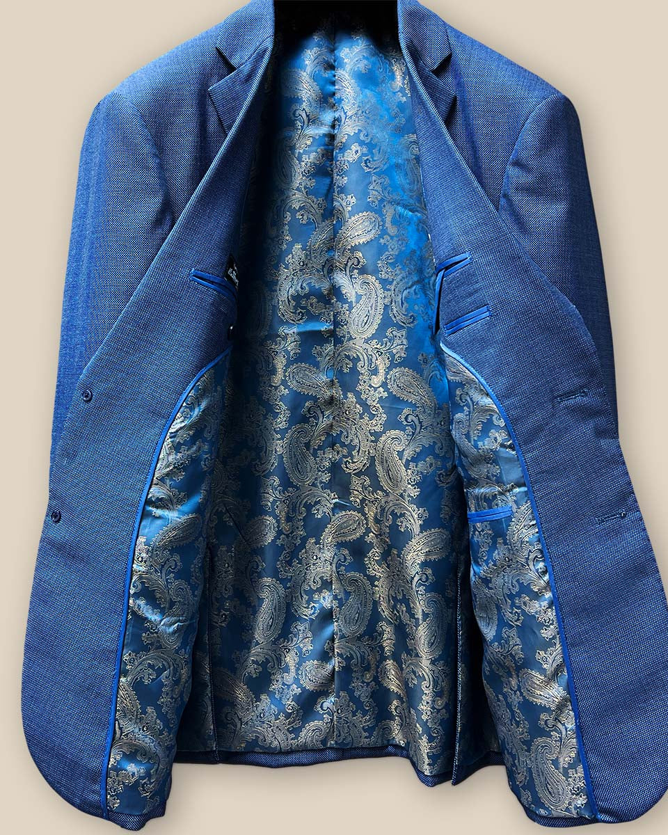 Full interior view of light blue suit jacket showcasing vibrant blue and gold paisley flash lining