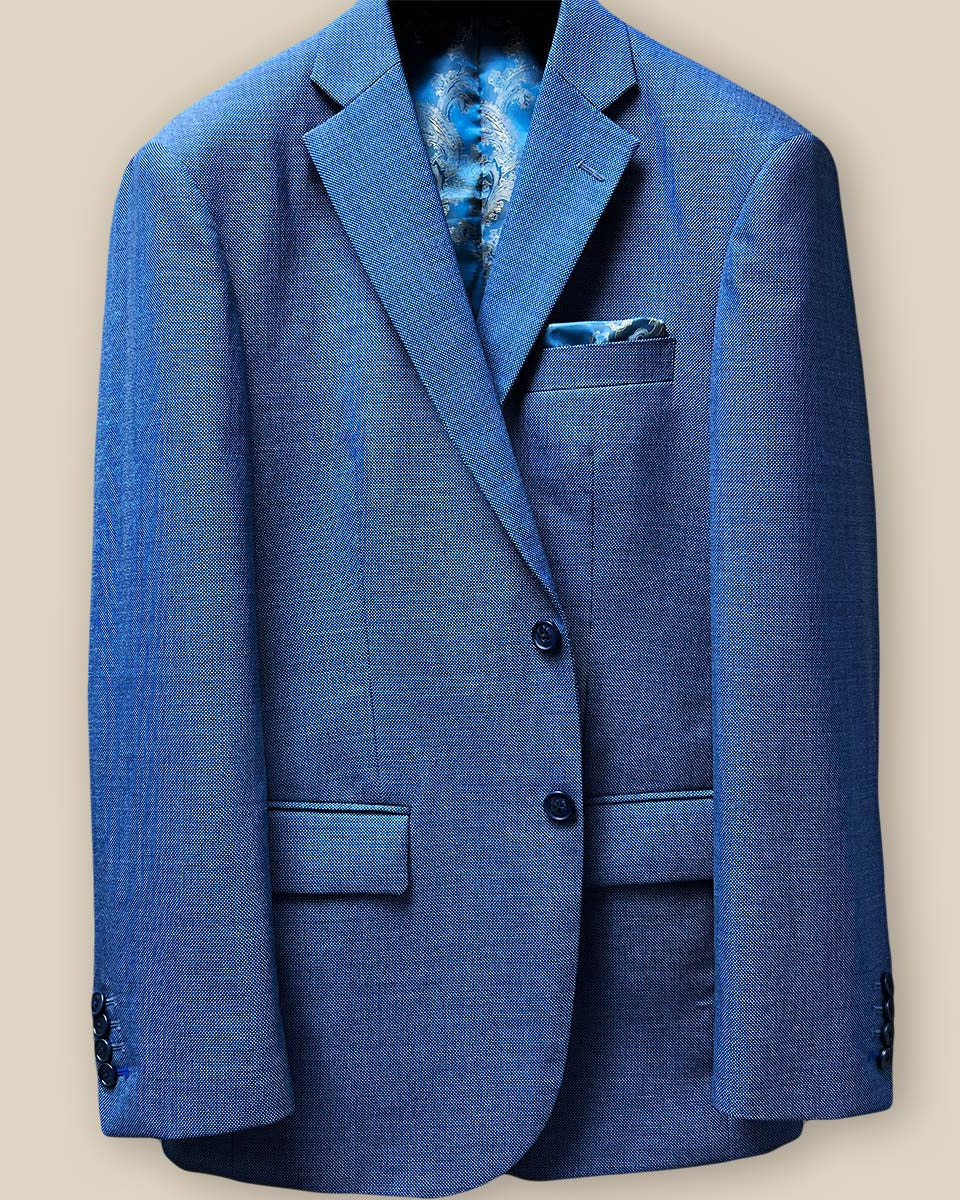 Close-up of light blue suit jacket front, showcasing navy horn marble buttons and buttonholes