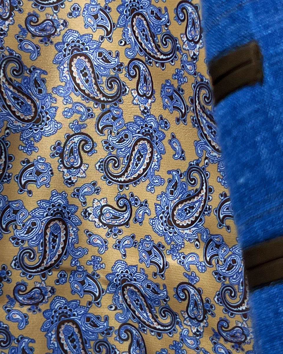 Decorative flash lining accents visible at jacket cuffs and interior edges featuring coordinated brown paisley pattern