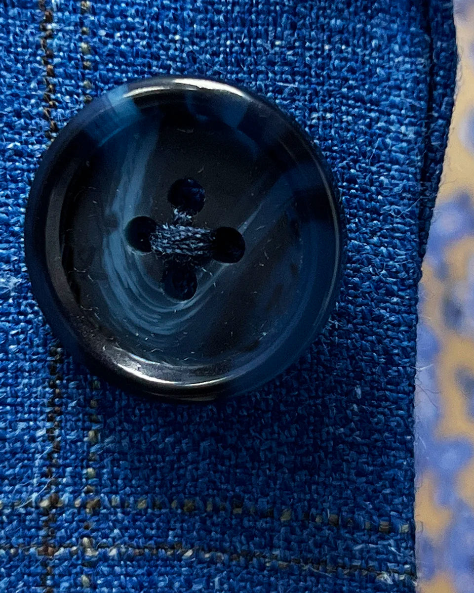 Detail shot of genuine navy horn buttons displaying natural marble patterns and premium button quality