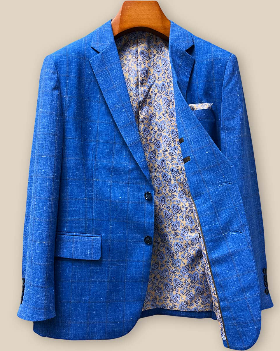 Interior left side view of custom sport coat displaying brown paisley lining with blue accents and internal pocket construction