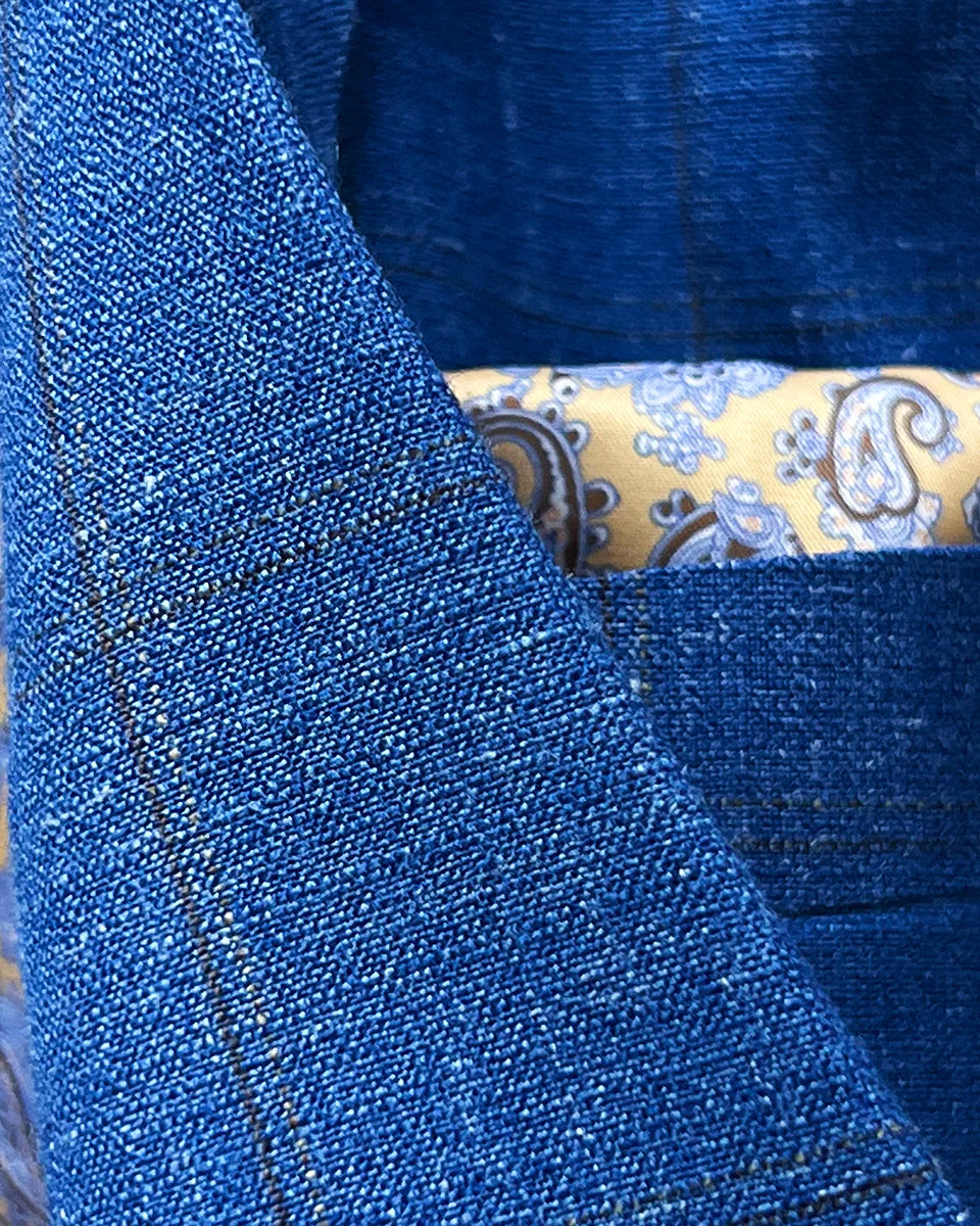 Chocolate brown contrast accent buttonholes on jacket front and sleeves demonstrating custom detailing