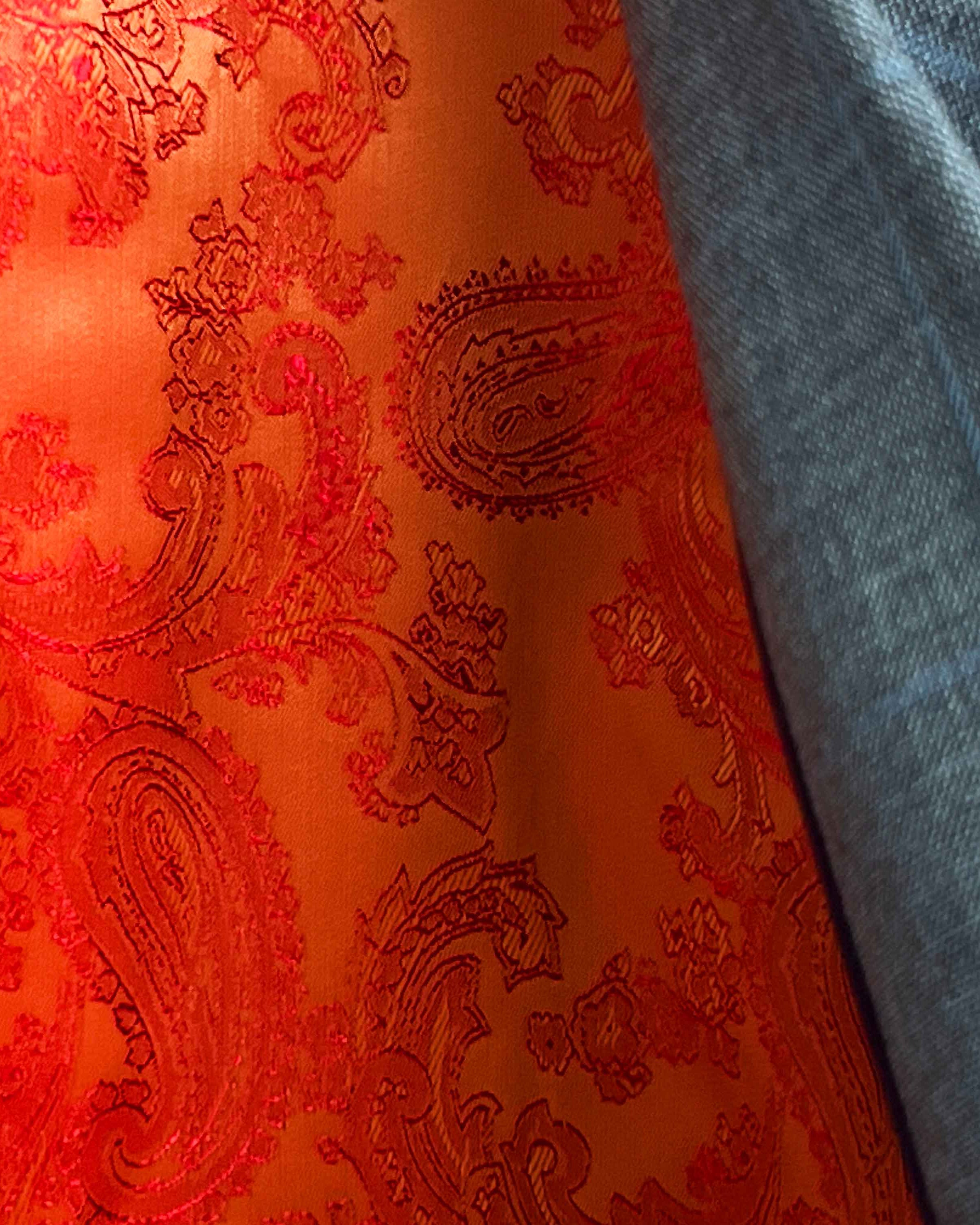 Colorful flash lining detail visible at jacket cuffs and vents in bright orange paisley jacquard pattern