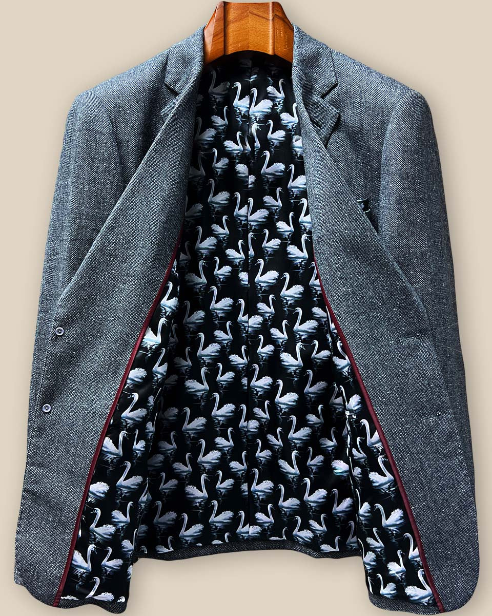 Full interior lining display showing playful black fabric with white swan pattern and contrasting maroon piping throughout