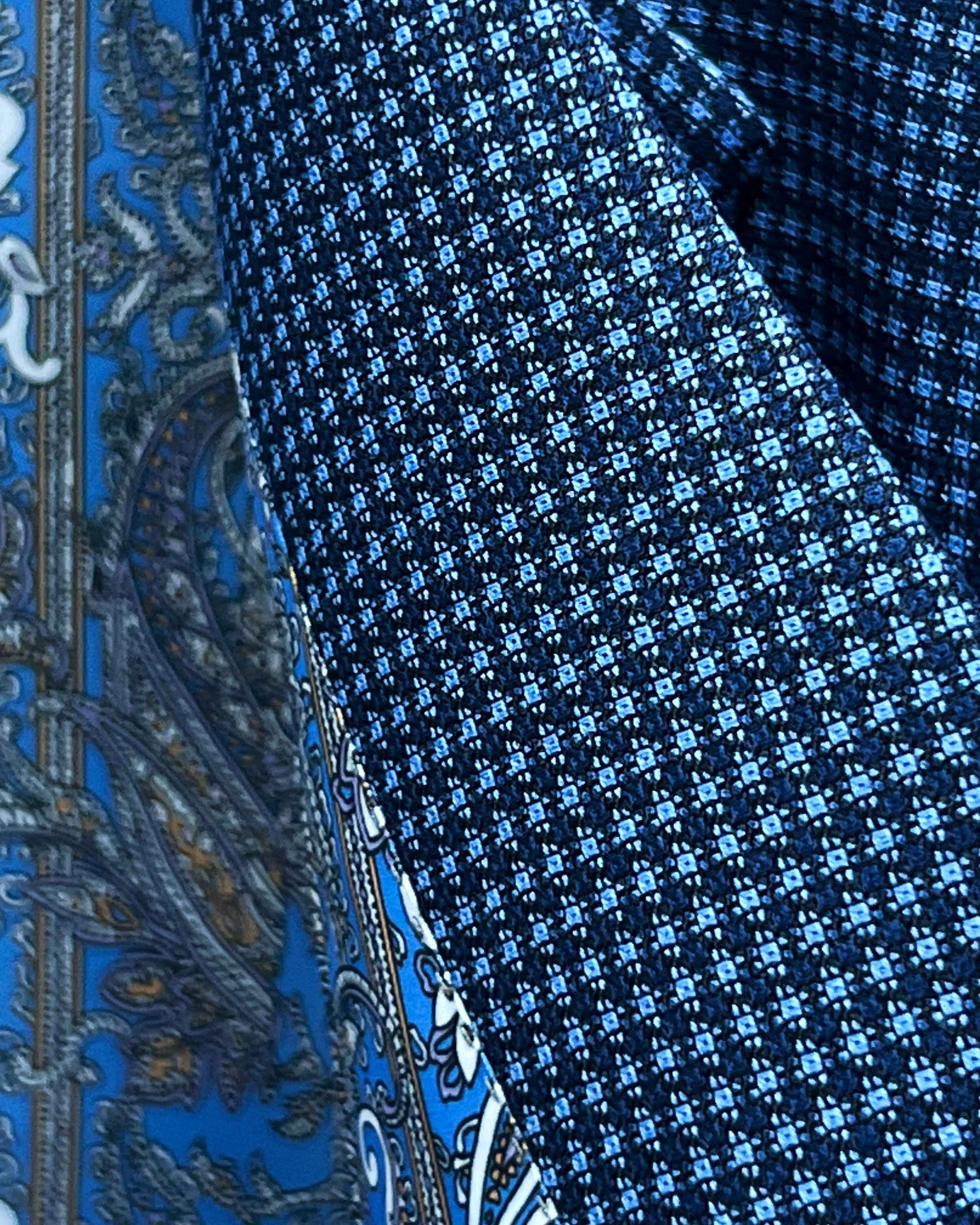 Close-up of Super 120s Australian merino wool fabric showing medium blue base with navy micro check geometric pattern