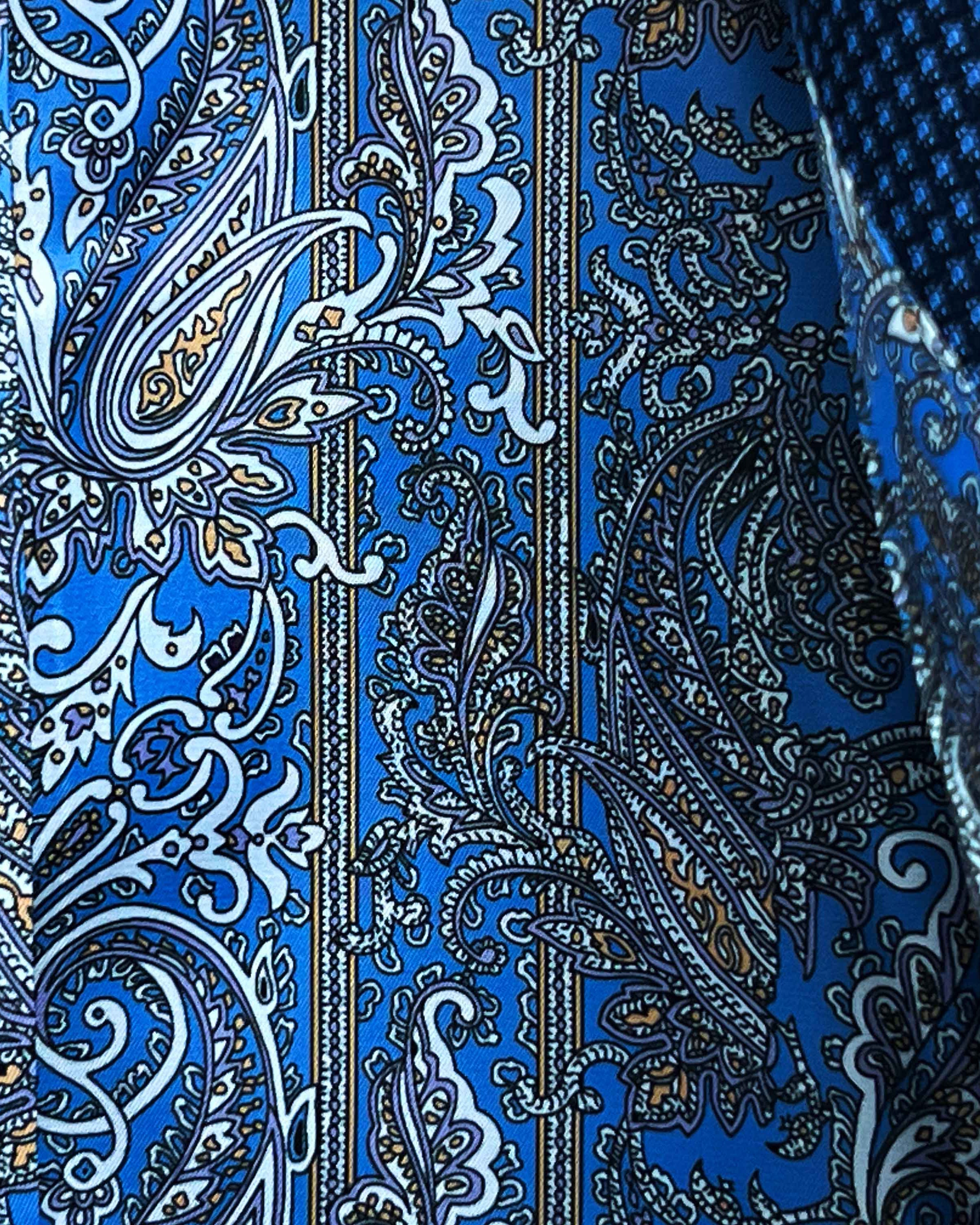 Colorful flash lining detail visible at jacket cuffs and vents in blue, white and gold paisley pattern
