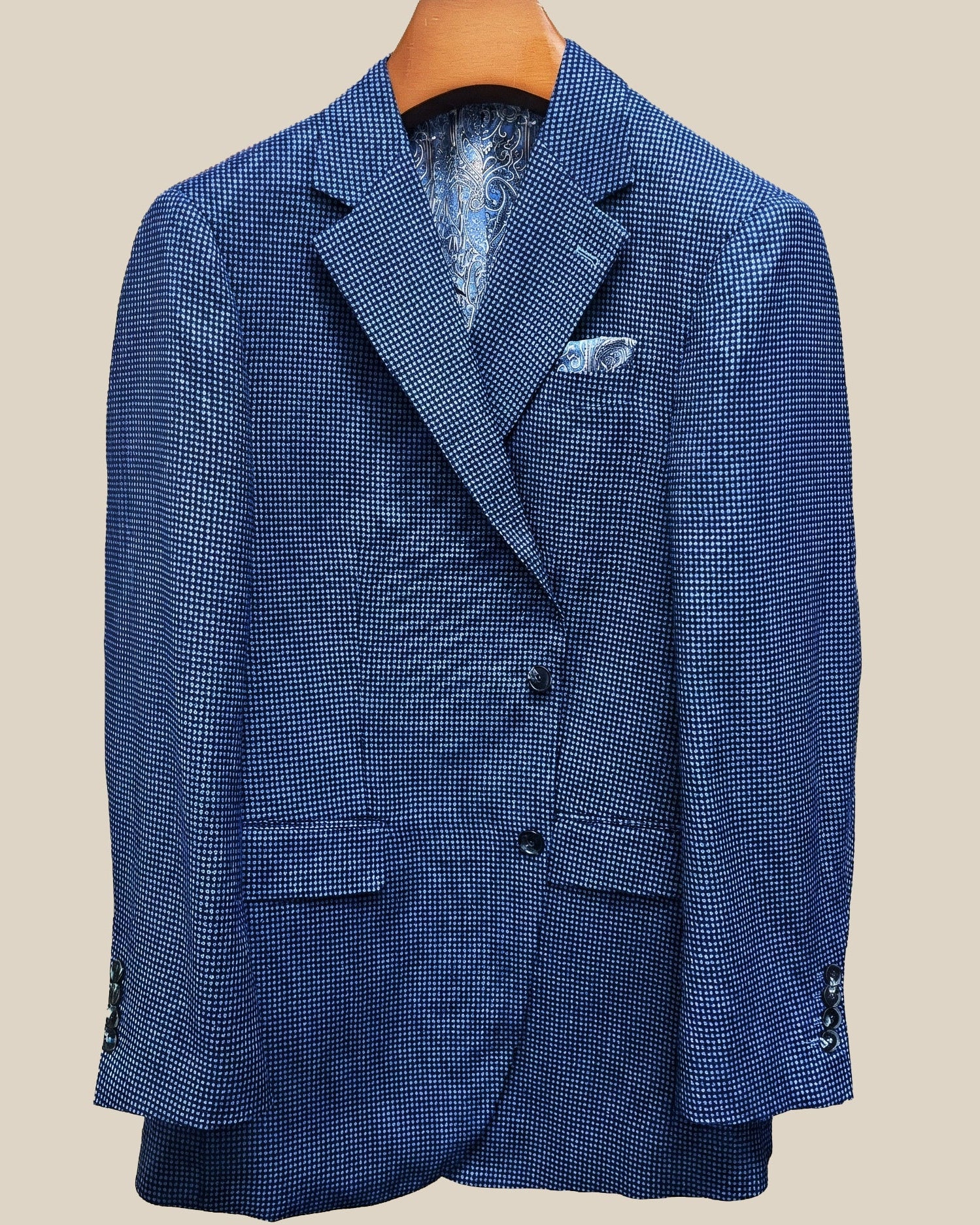 Front button panel of medium blue micro check sport coat featuring navy marbled horn buttons and hand pick stitching