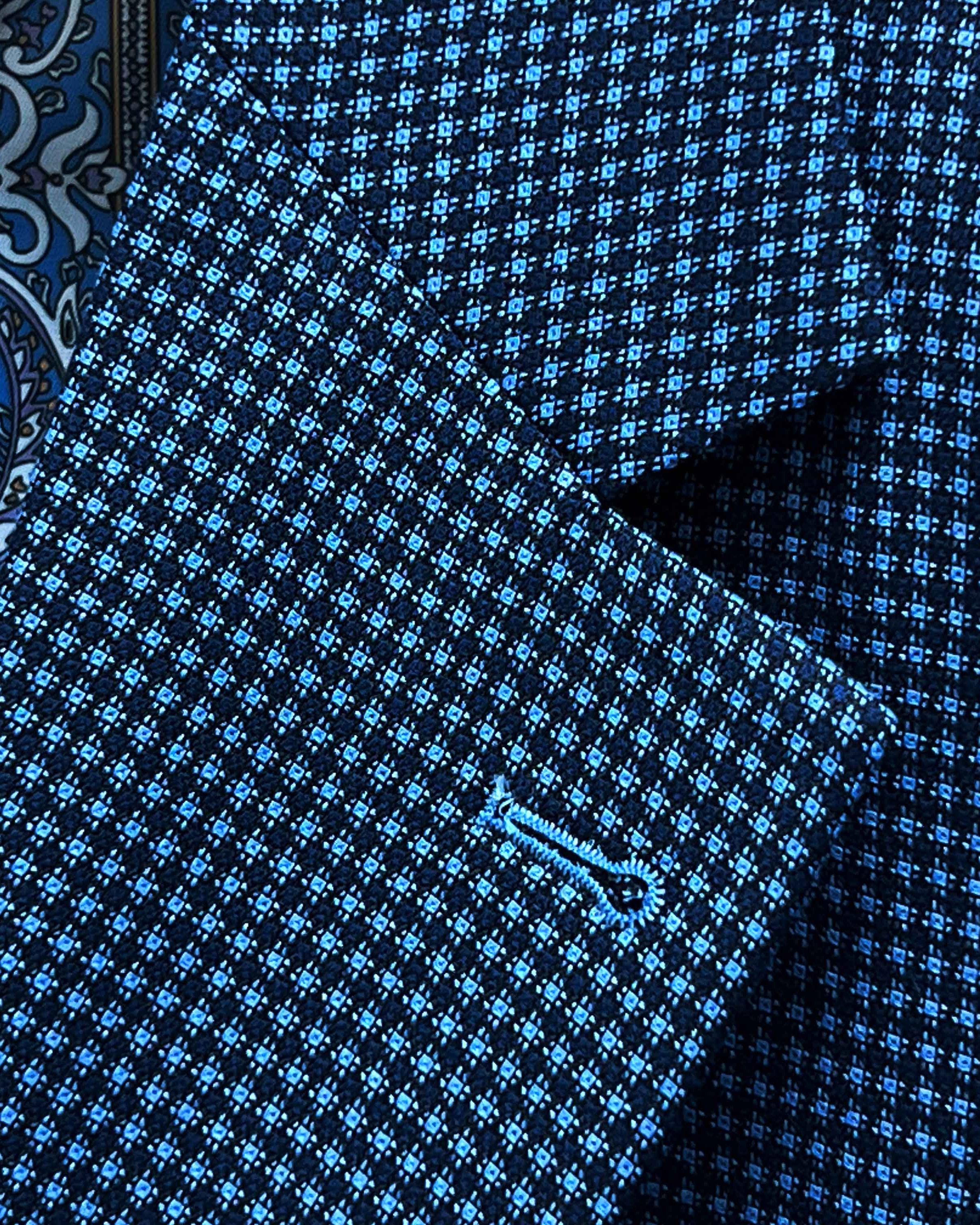 Classic notch lapel detail on medium blue micro check sport coat showing hand pick stitching and navy geometric pattern