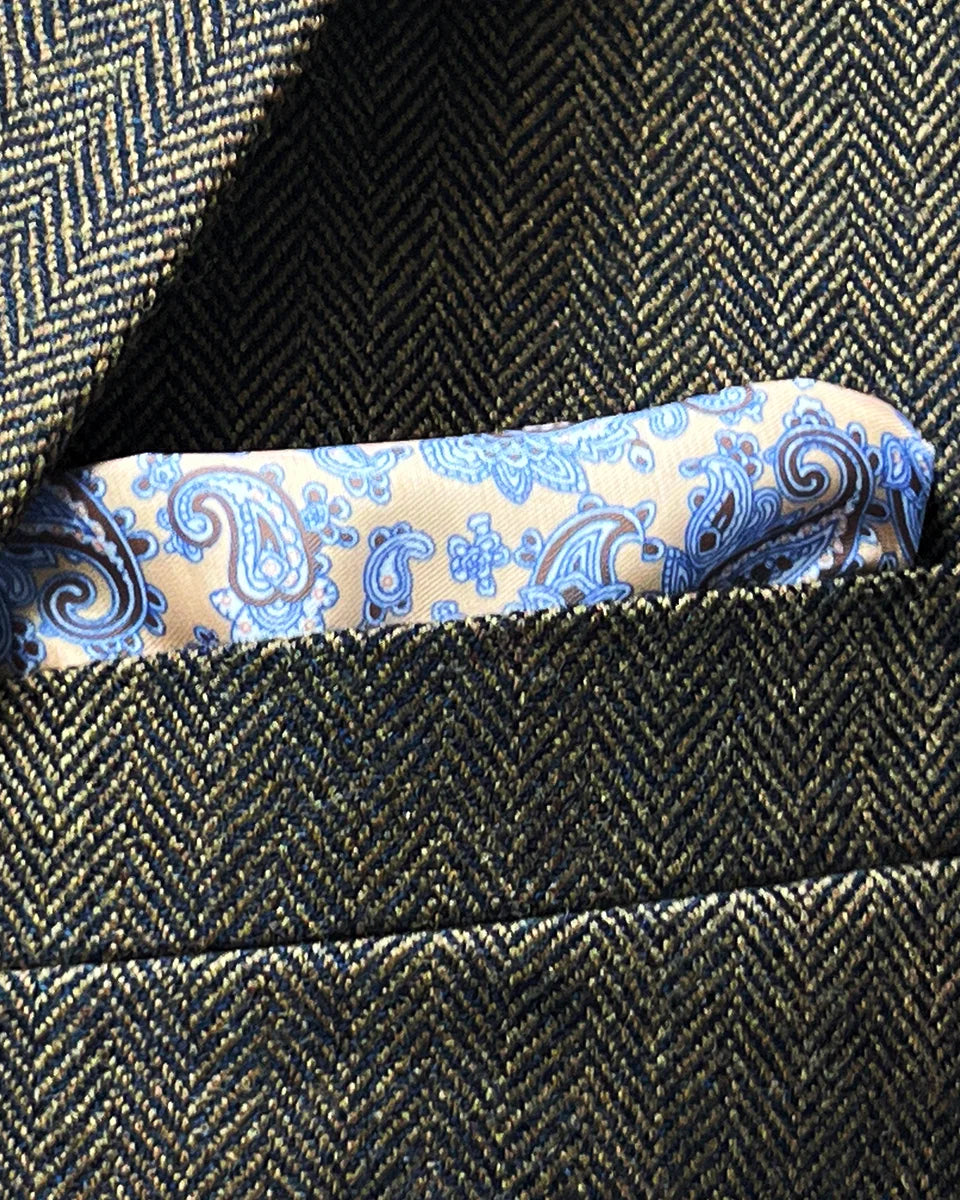 Chest pocket styling with coordinated pocket square demonstrating proper folding technique and color harmony