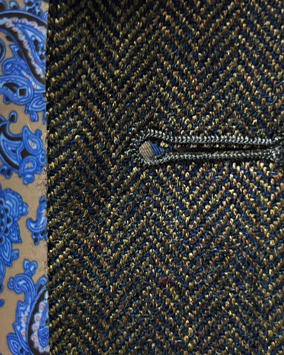 Macro view of precise hand-stitched buttonhole work showing superior craftsmanship and attention to finishing details