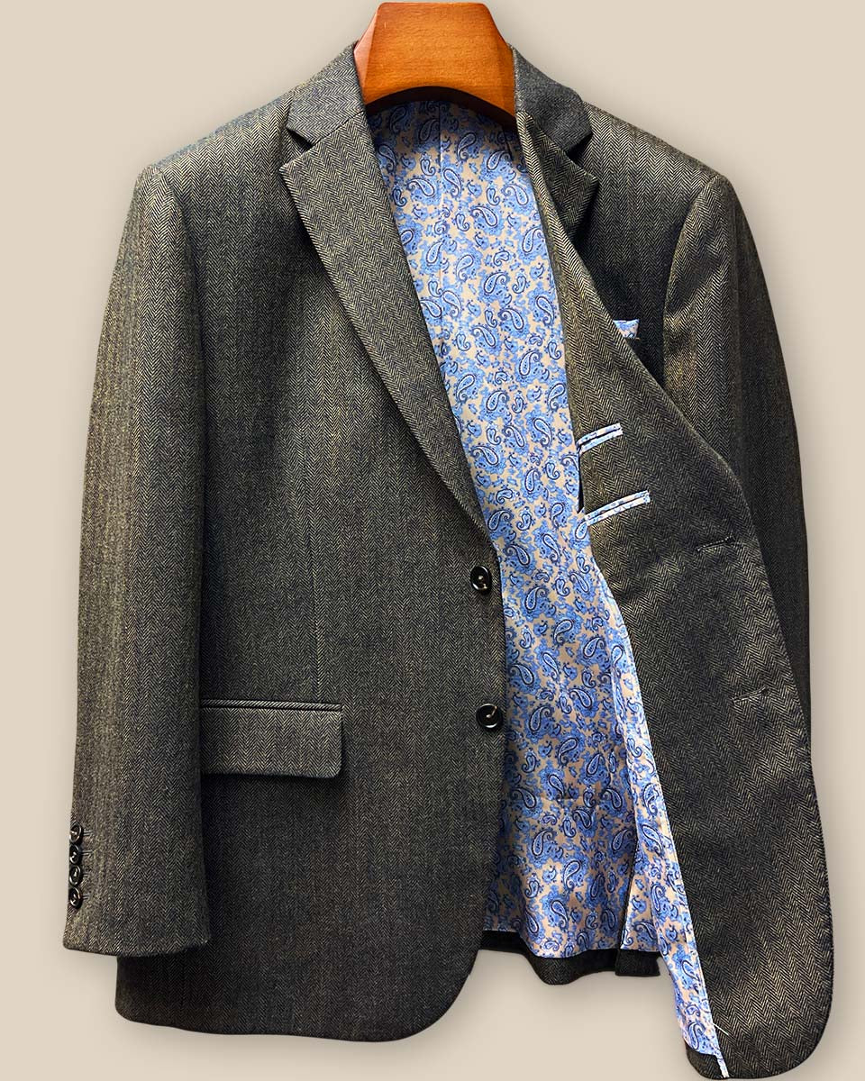 Interior left side view displaying vibrant blue and gold paisley lining with inner chest pocket and superior construction details