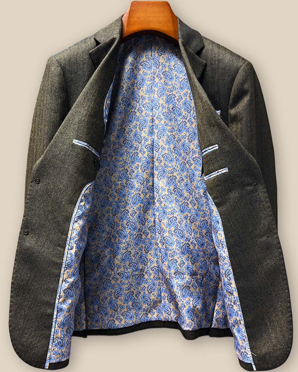 Full interior lining showcase featuring luxurious blue and gold paisley pattern with branded label and quality finishing touches