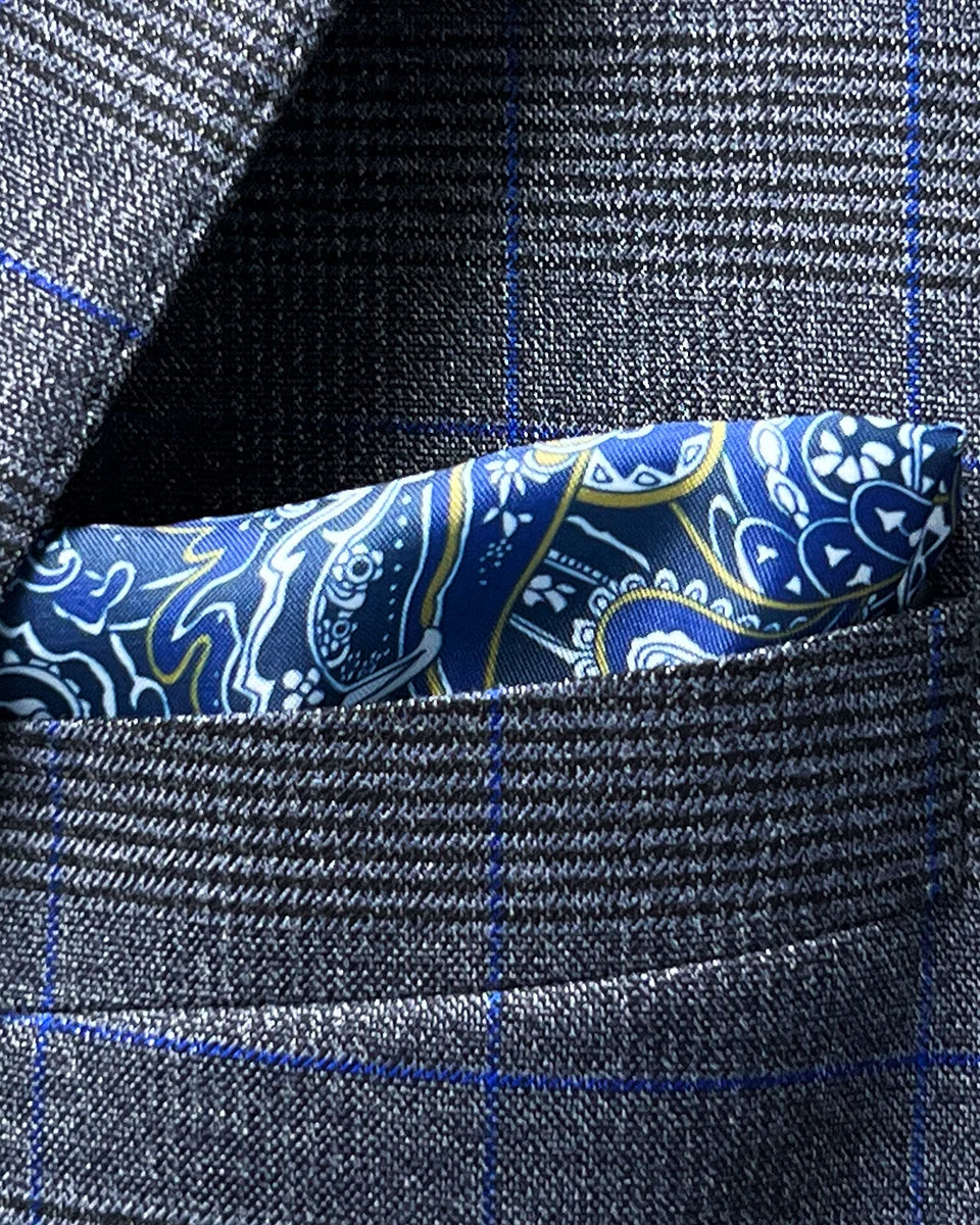 Creative view showing how the blue paisley lining could be fashioned into a built-in pocket square option, complementing the suit's blue windowpane accent
