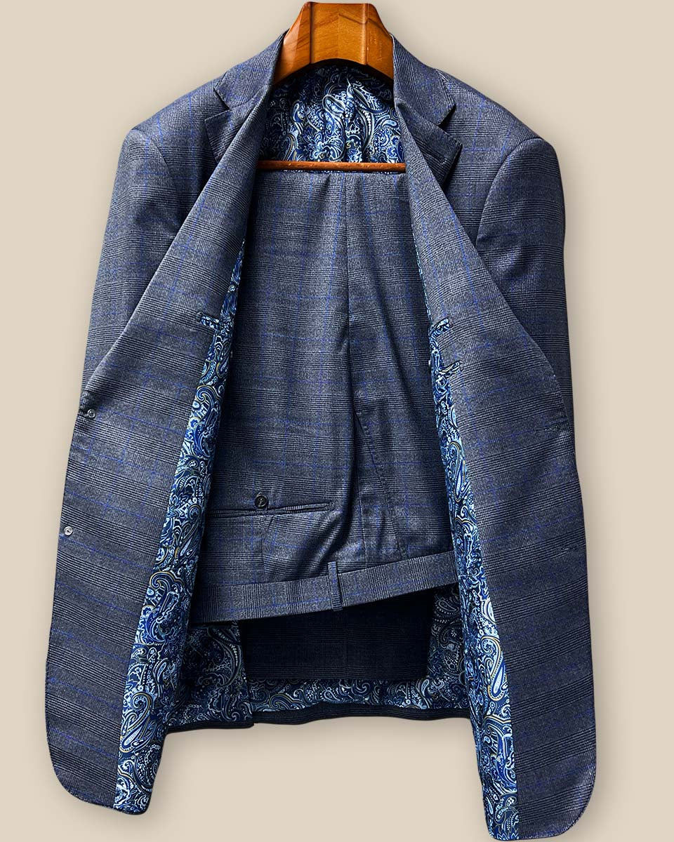 Front view of the complete two-piece custom suit in medium grey super 130s Australian merino wool featuring the Prince of Wales windowpane pattern with subtle blue lines
